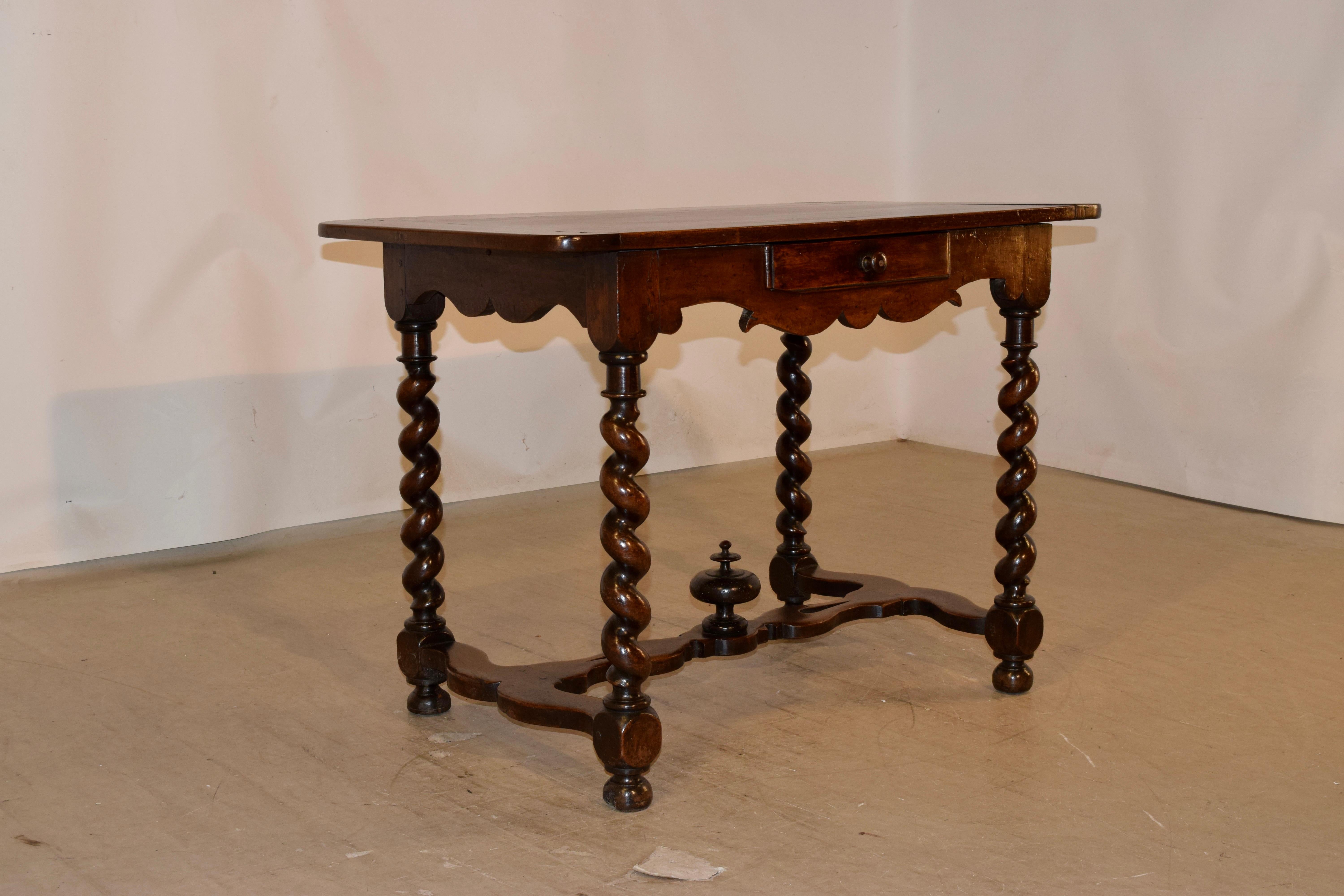 Mid-18th-century walnut side table from France with banded ends on the top, over wonderfully hand scalloped aprons on three sides and a single drawer in the front. The table is finished on all four sides for easy placement in any room. The table is
