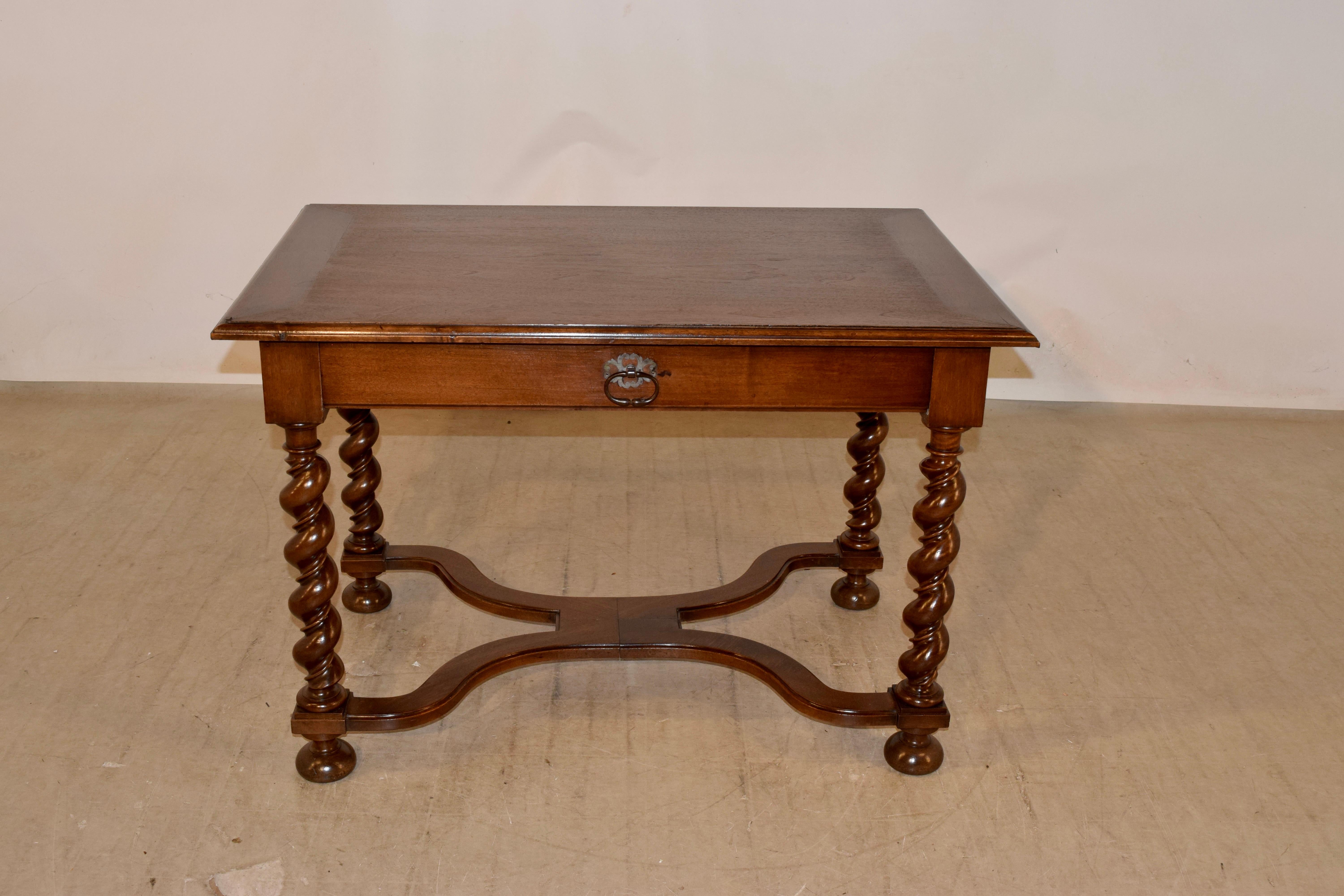 18th century walnut side table from France. The top is banded and has a lovely beveled edge, over a simple apron containing a single drawer in the front. The table is supported on hand turned vine barley twist legs and are joined by serpentine