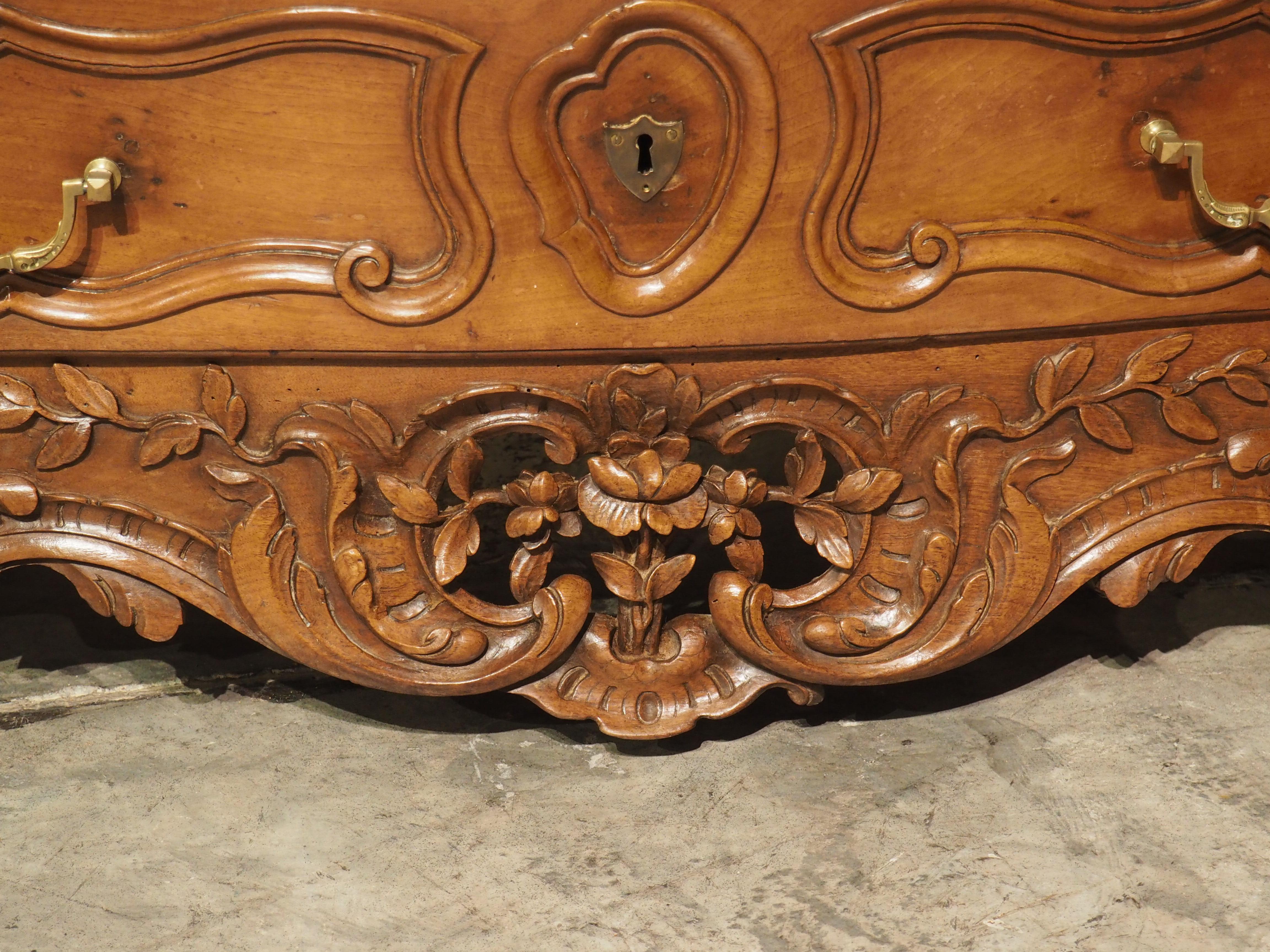 An en tombeau is a type of commode with three tiers of drawers and short legs. Our walnut wood chest of drawers was hand-carved in Provence, France during the 1700’s and features floral and foliate décor and four pronounced hoof feet.

The shaped