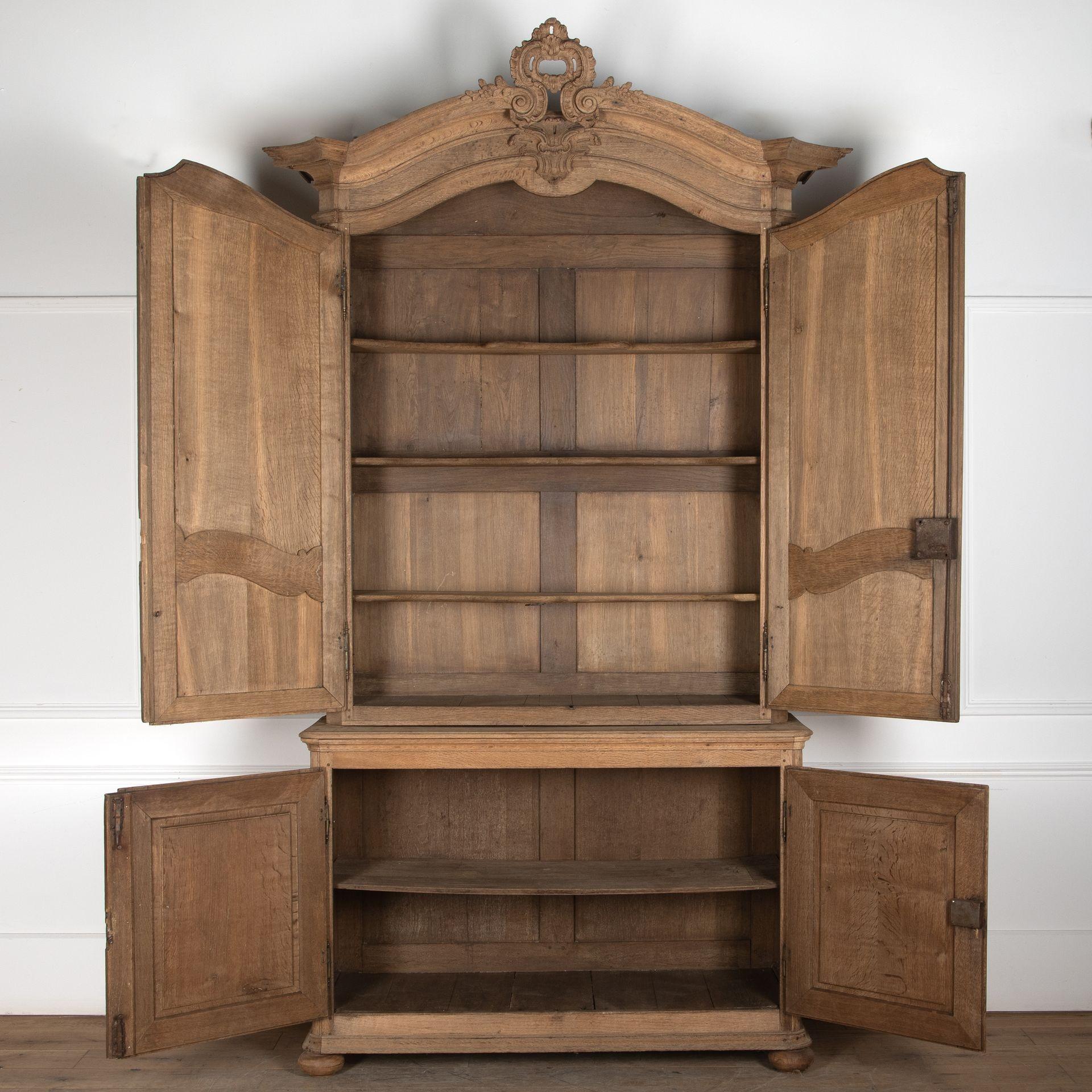 18th century French washed oak buffet deux corps. 
Made in two sections which have beautiful wood carvings and lovely deep mouldings. 
Comes with two working iron keys.