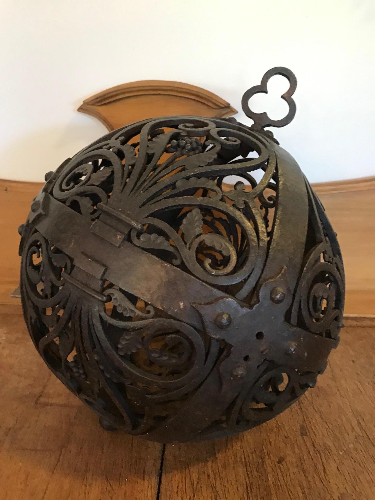 Amazing 18th century French wrought iron decorative ball with carved bunch of grapes. 
Beautiful ironwork. 
Can be hang on the top. The ball is not openable. 
May have been a garden ornament. 
Very nice quality and very rare piece.
