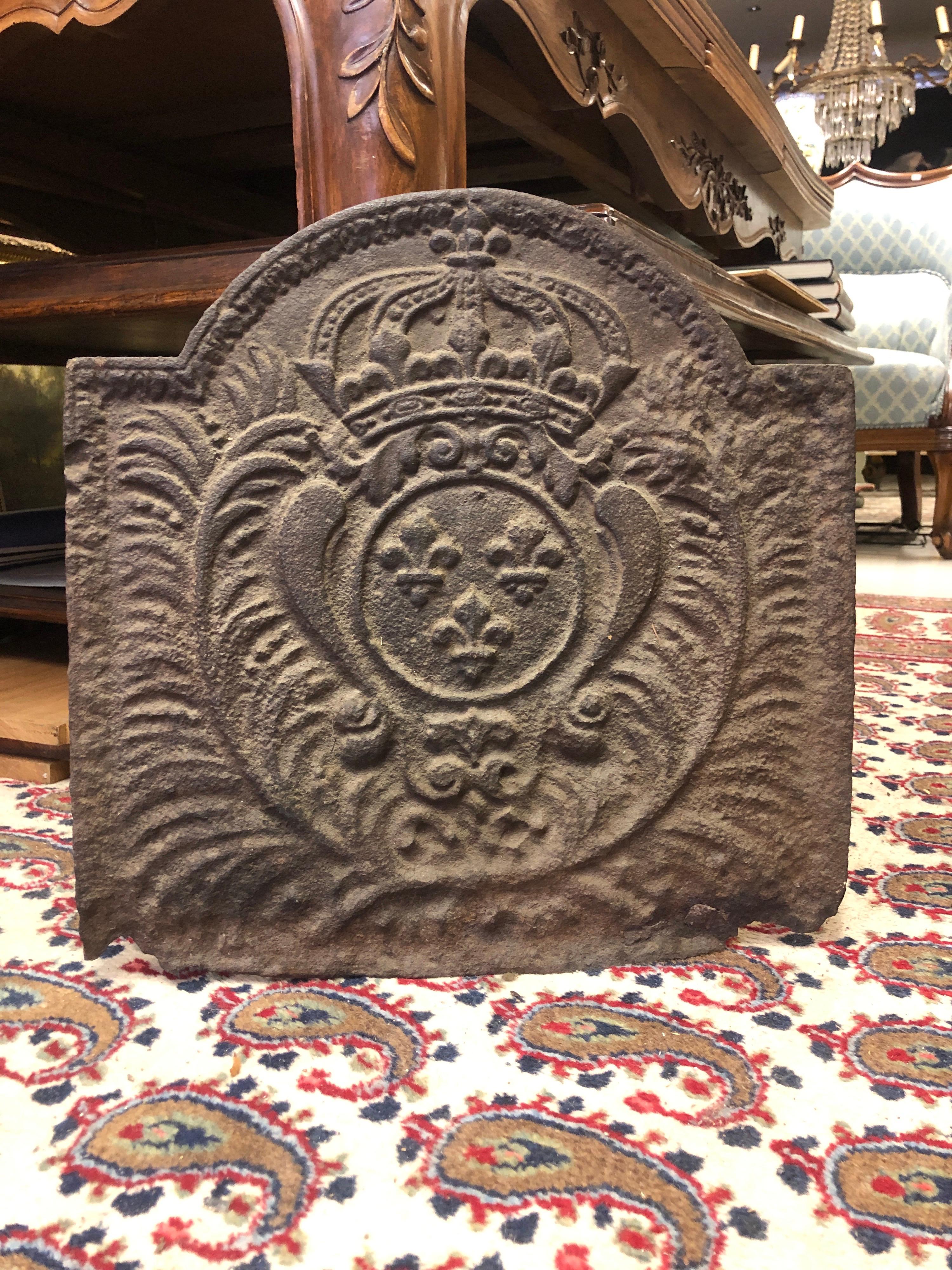 This antique iron fire back plaque was crafted in France, circa 1800.
This forged piece could be used inside a fireplace hearth to re-direct heat, or as a back splash behind the stove in a kitchen.