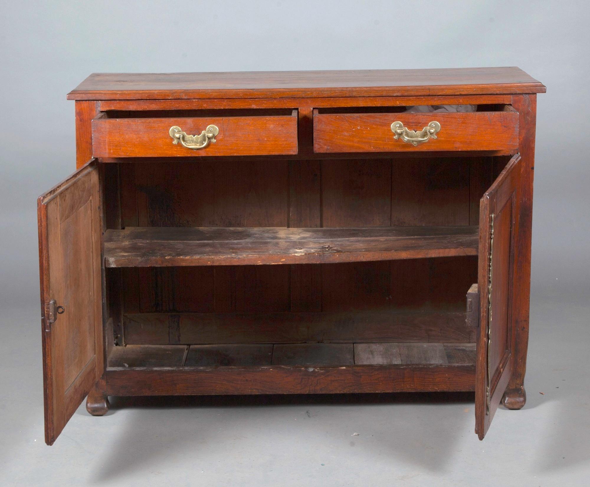 Crafted in the mid-18th century in the United States, this fruitwood continental style sideboard/cabinet exemplifies exceptional American craftsmanship. The cabinet features exterior brass hardware trim, adding an elegant touch to its robust design.