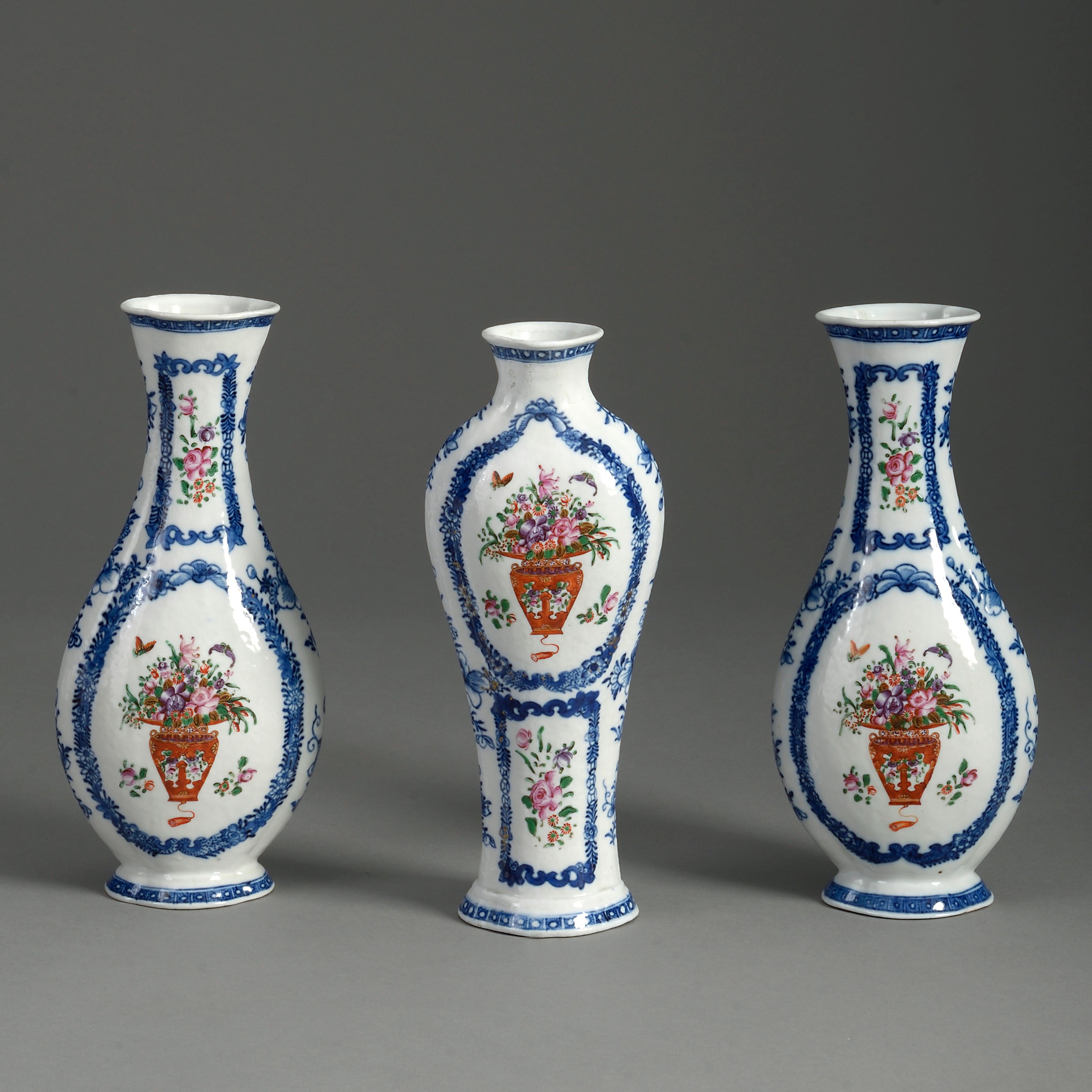A garniture of three late 18th century porcelain vases, decorated with floral decoration upon a white ground.

Qing Dynasty, Qianlong Period

(One neck restored).