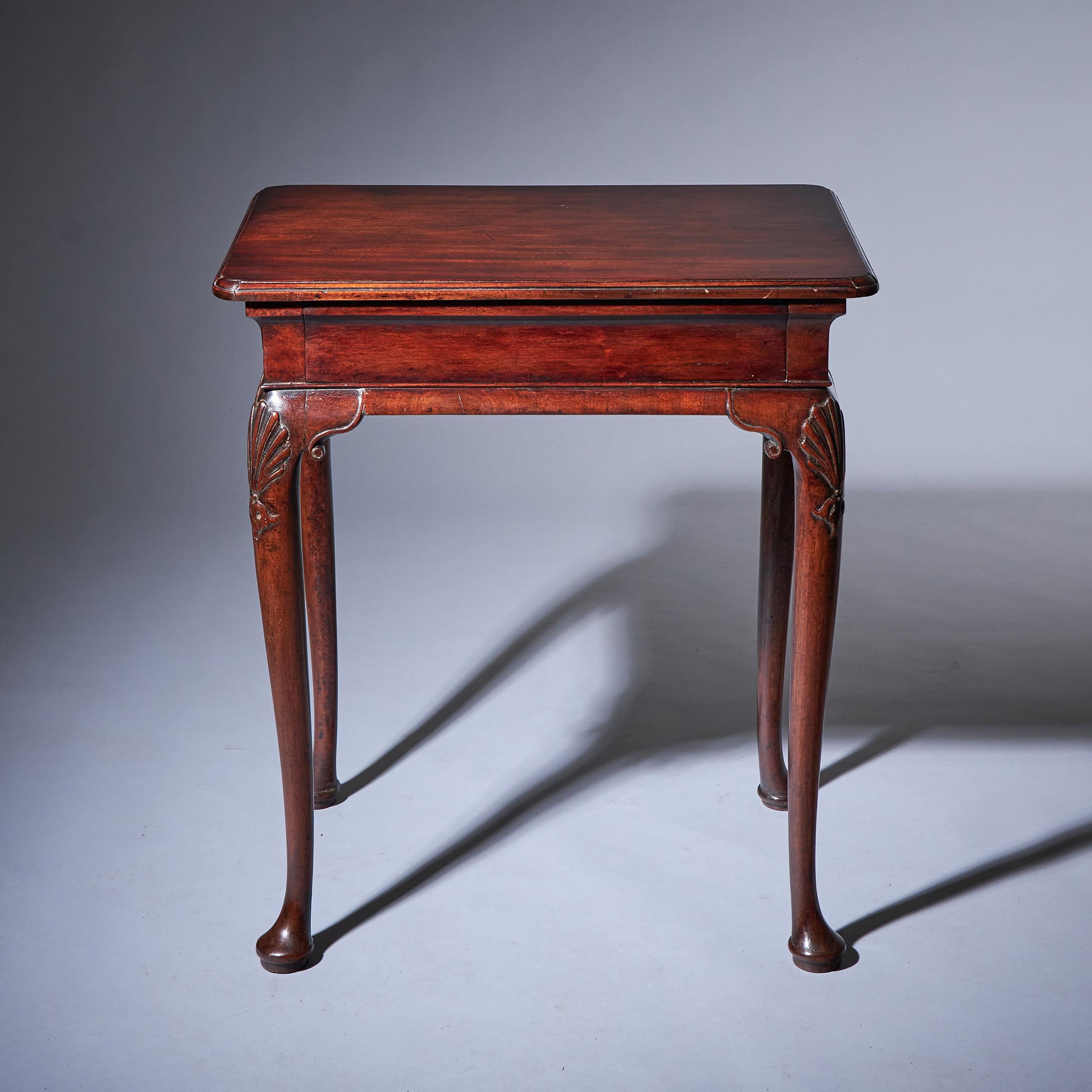 A fine and rare small George I mahogany table of diminutive proportions, circa 1725. England

The top, moulded to all sides and with reentrant corners sits above a cavetto frieze fitted with a finely lined drawer raised on scrolled ear cabriole