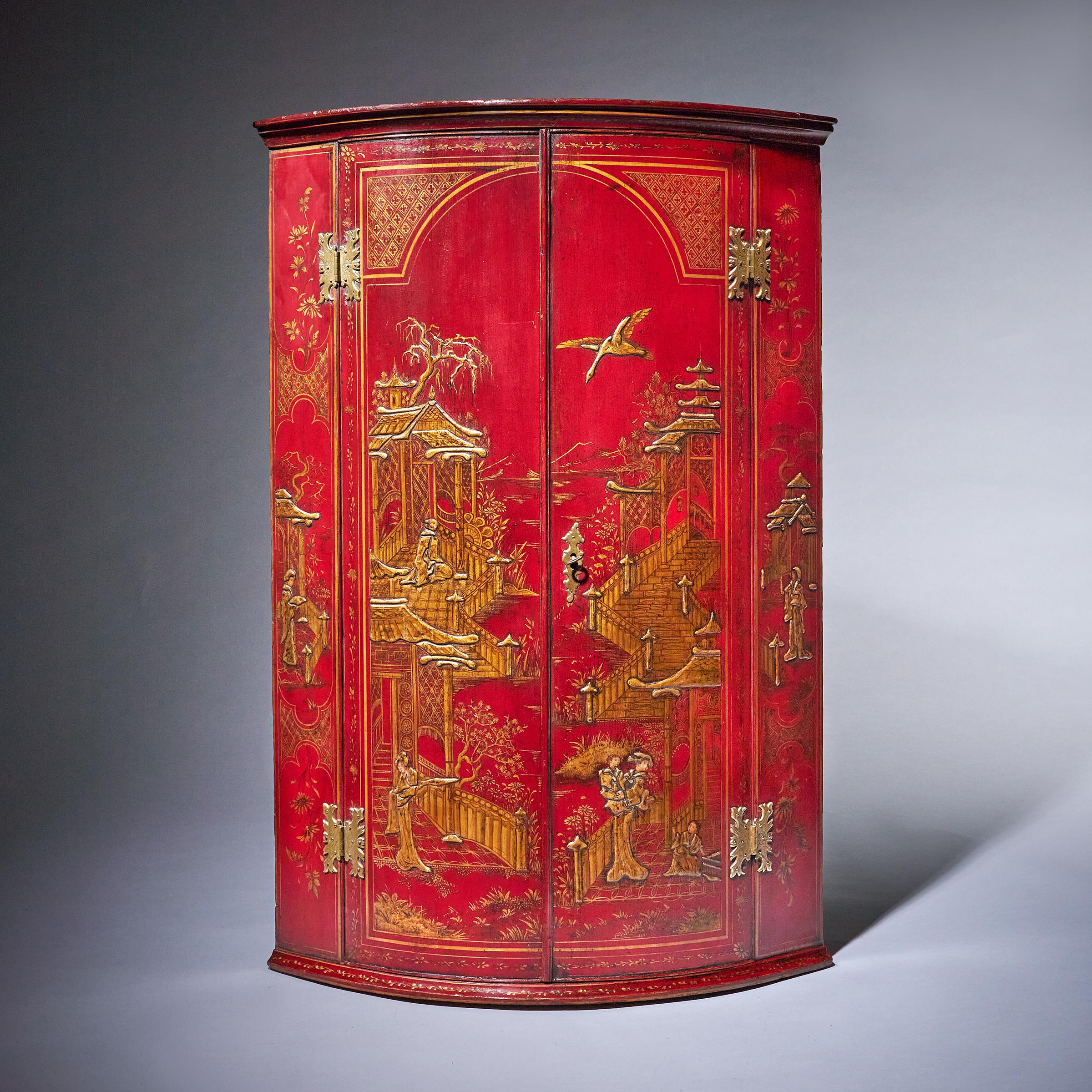 A fine and rare early 18th century George II scarlet japanned chinoiserie wall hanging corner cupboard. C. 1730-1740. 

Attributed to Giles Grendey. 

Decorated overall with elaborate Chinoiserie figures and foliage, the moulded cornice above a