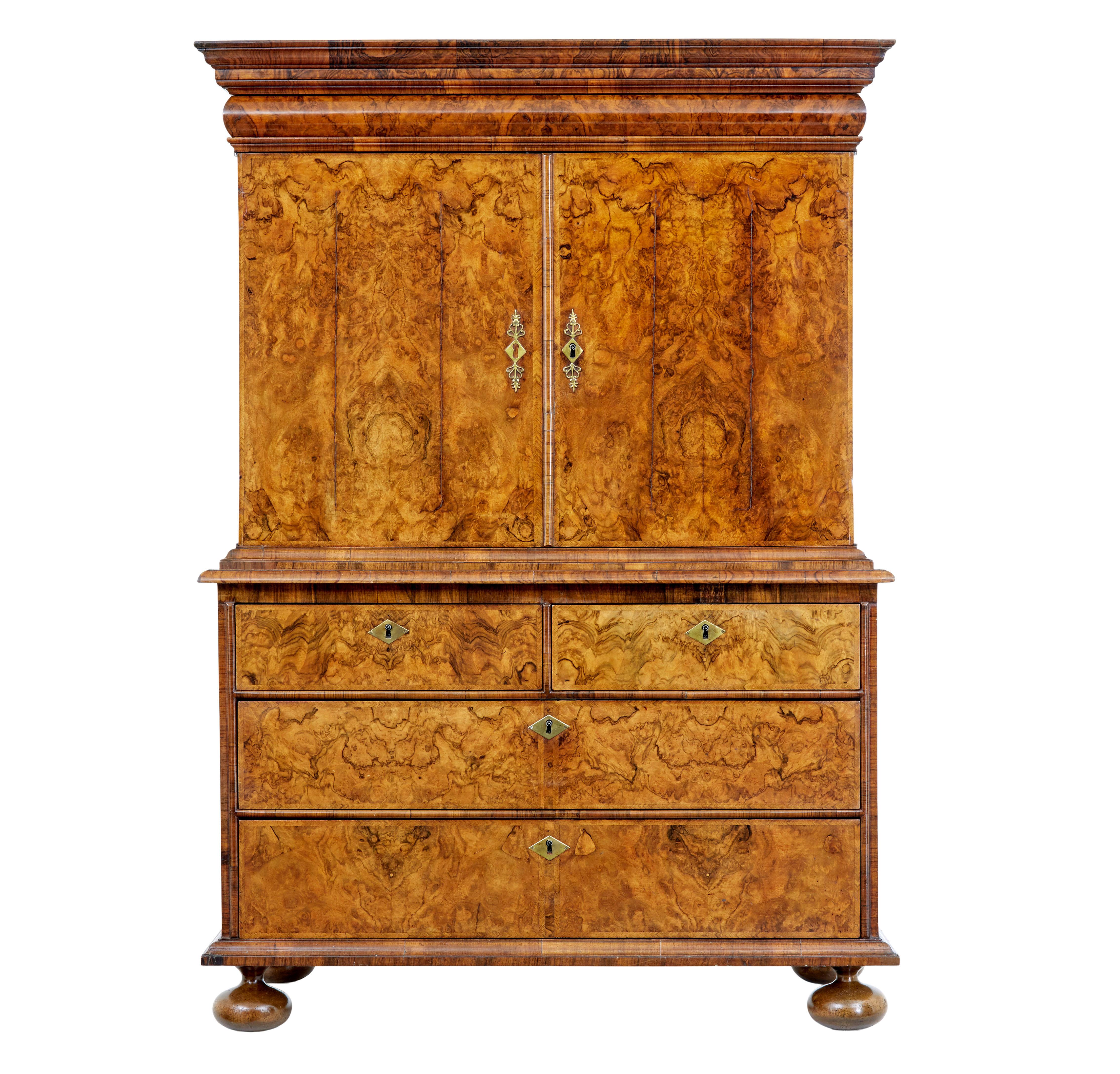 18th century George I walnut cabinet on chest circa 1710.

We are pleased to offer this stunning cabinet in the manner of Coxed and Woster.

The piece is lavishly veneered in burr walnut, with a burr elm interior which was coloured the same as