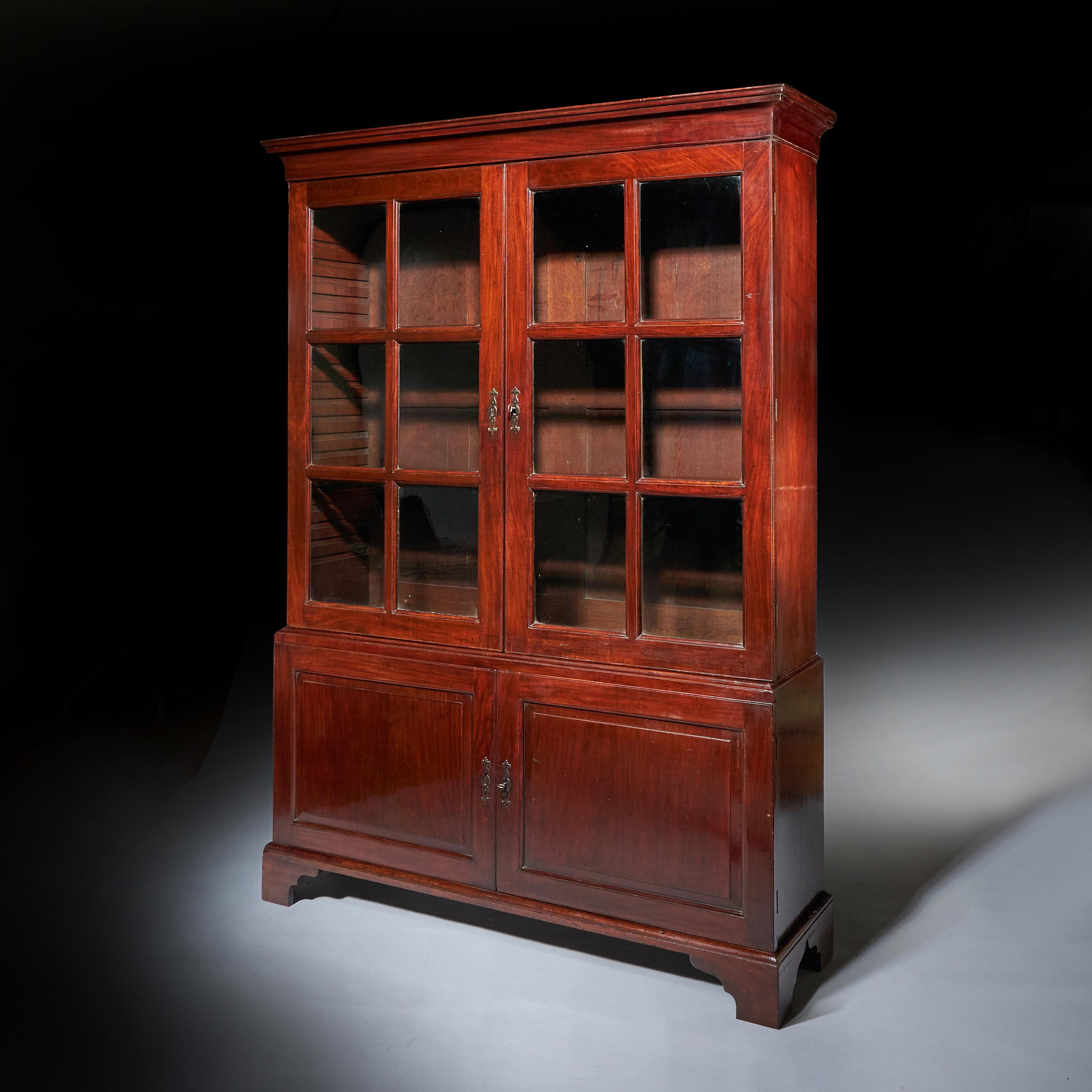 18th Century George II Chippendale Period two-door mahogany Glazed bookcase, circa 1750

The concave cornice sits above a pair of glazed doors. The antique glass is divided by moulded glazing bars, opening to the original adjustable shelves.