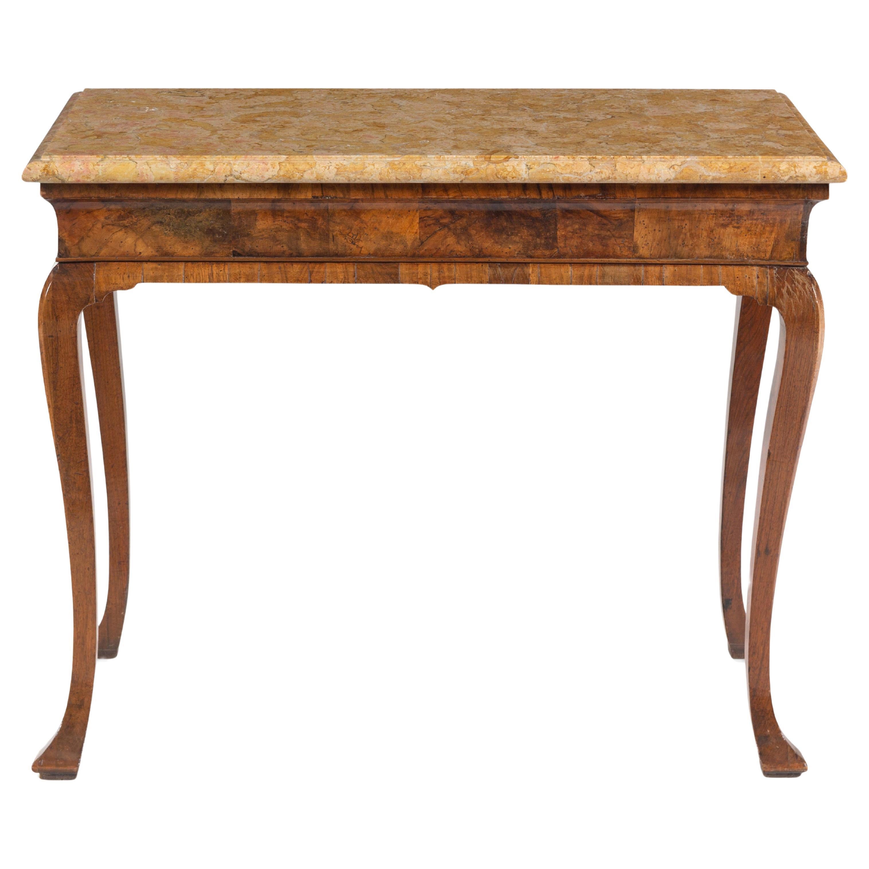 A fine George II figured walnut console table with Sienna Brocatelle marble top, circa 1740. England

The moulded Sienna Brocatelle marble sits over a figured walnut moulded cavetto frieze, raised on eared solid walnut legs terminating on shaped pad
