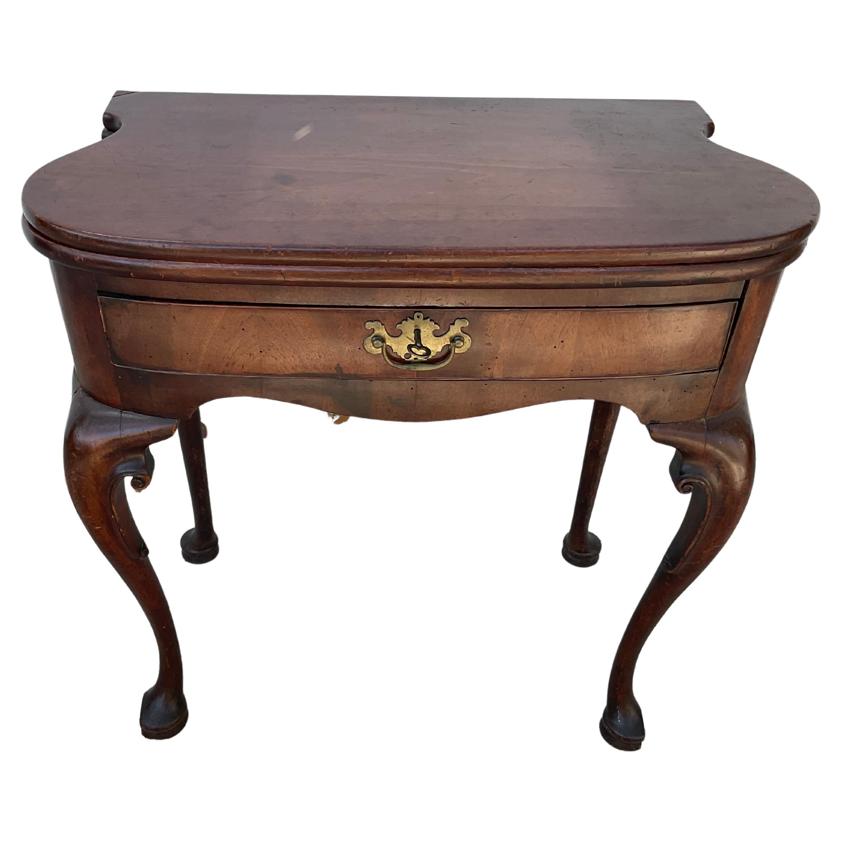 18th century George II mahogany game / tea table. Has flip top and one drawer. Table is 30.75 inches when opened. This is a rare form with the exaggerated shaped sides. Wonderful old warm rich patina.