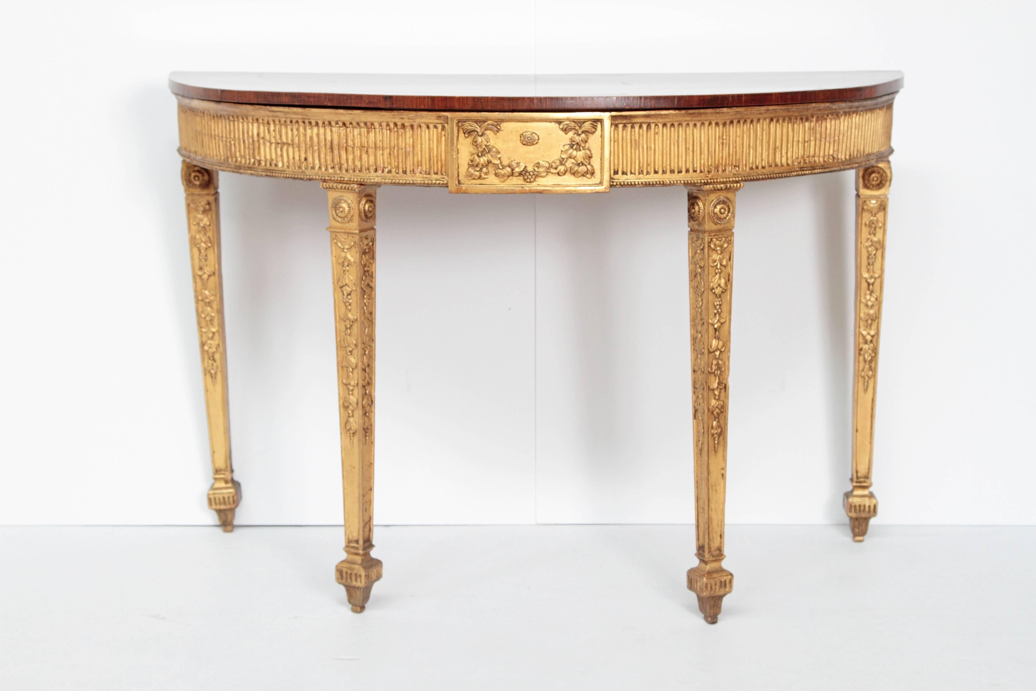 An English George III Adam pier table. Giltwood carved legs and apron. Satinwood top with painted accents, England, 1780.