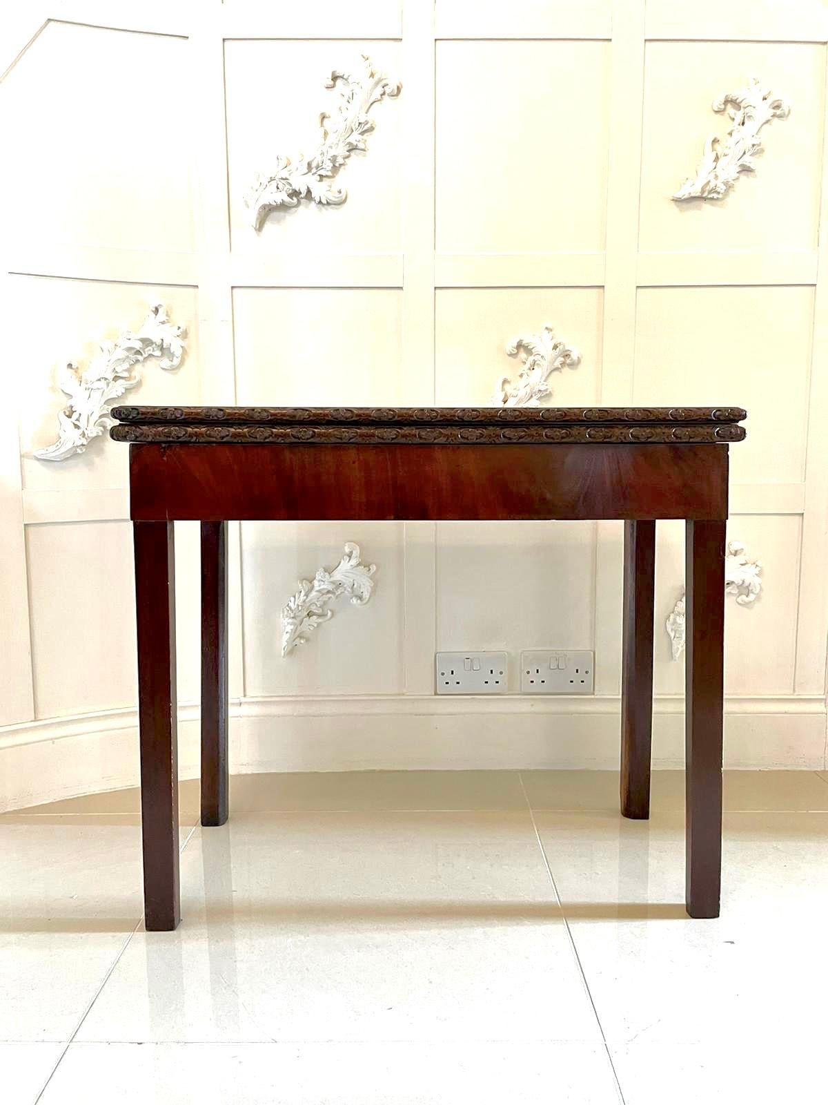 18th century George III antique Chippendale mahogany carved card/side table having a lovely fold over top with a charming quality carved edge opening to reveal a green baize interior. It stands on four square tapering legs.

This handsome period