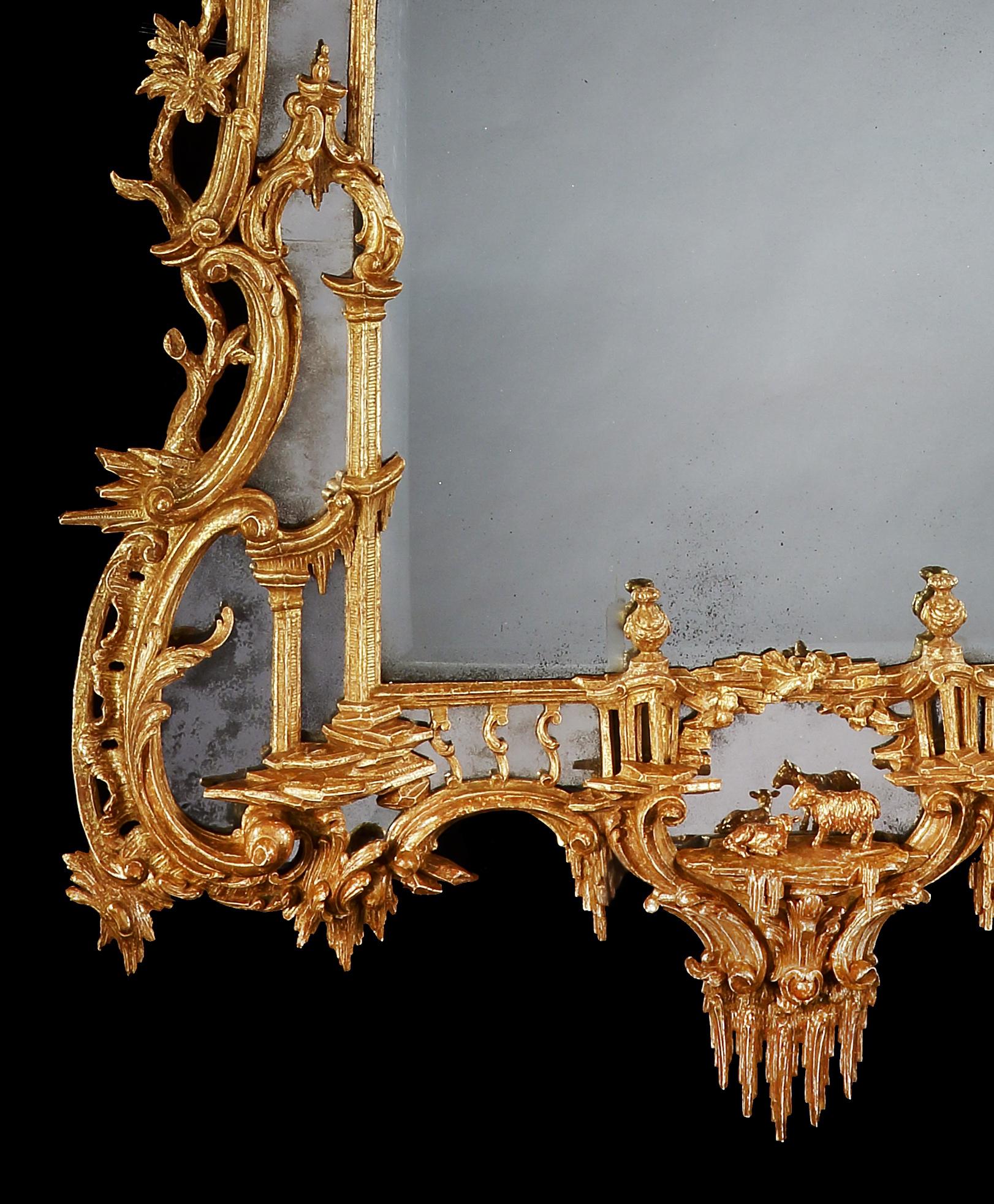 A George III Giltwood Pier Mirror
In the Manner of Thomas Johnson

An exceptionally detailed design; the superb carved decoration housing a shaped rectangular plate and undulating mirrored borders; the inner frame closely tied to the outer frame