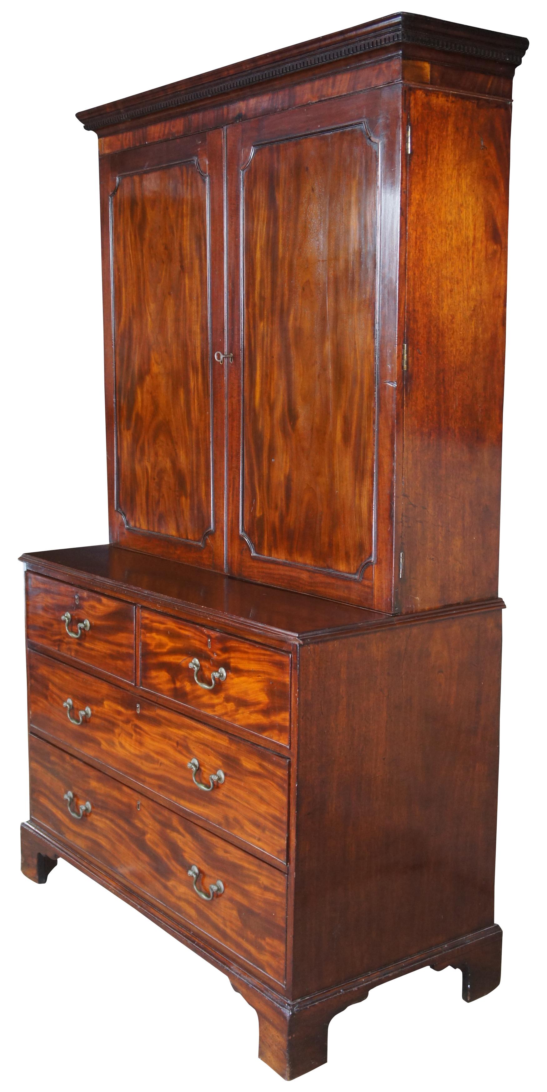 18th century George III English mahogany linen press. Rectangular form with two over three hand dovetailed drawers and stepback closet/wardrobe. Features a carved crown with ogee edge, bracket feet and brass bail hardware.

Measure: Surface height