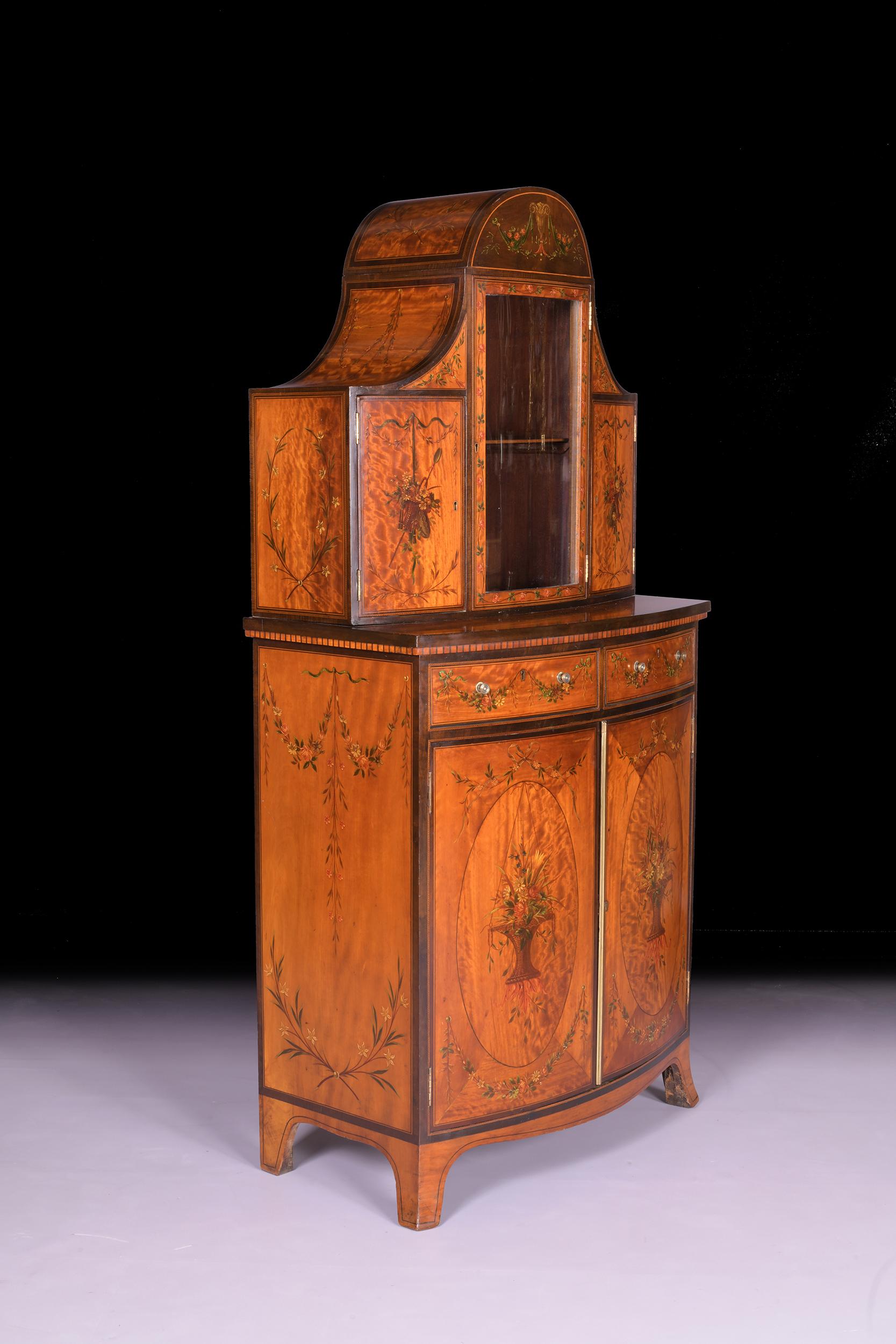 A very fine George III satinwood and hand painted side cabinet, the superstructure with central mirror backed arch display case, flanked by painted panelled doors on either side. The projecting with two frieze drawers above 2 bow shaped painted