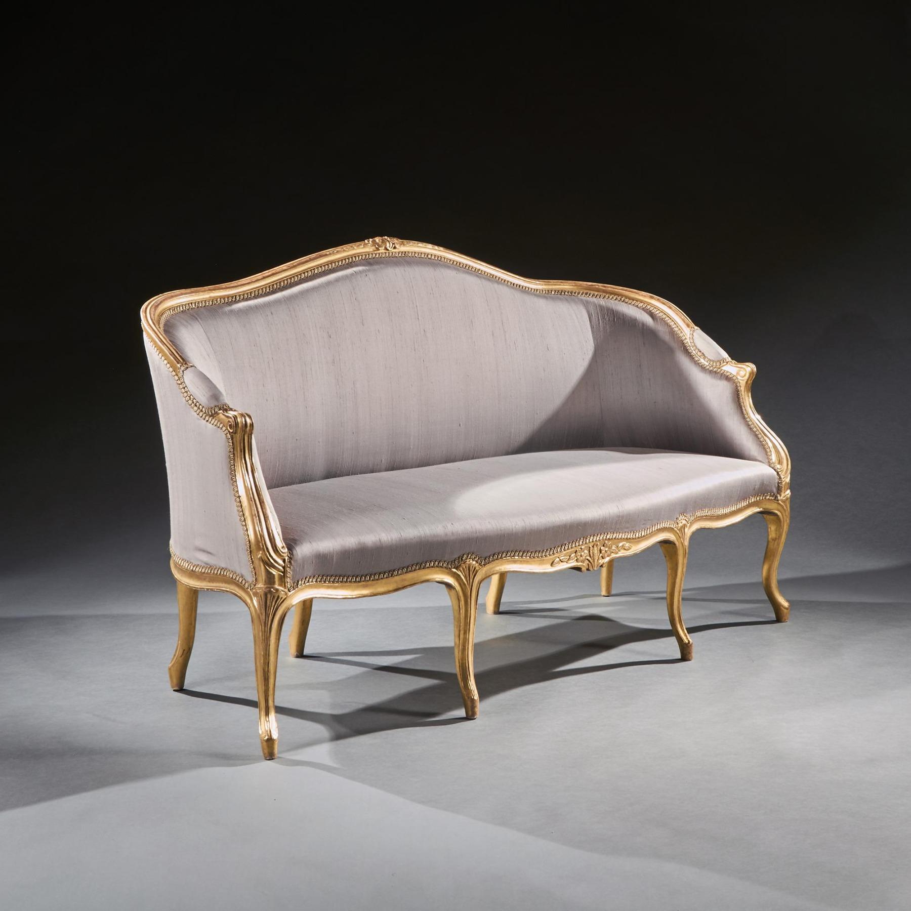 A very elegant and well drawn 18th century George III giltwood settee / sofa / canapé in the French Hepplewhite taste upholstered in a grey silk.


English Circa 1775


Of elegant French form, the moulded frame having a padded serpentine back