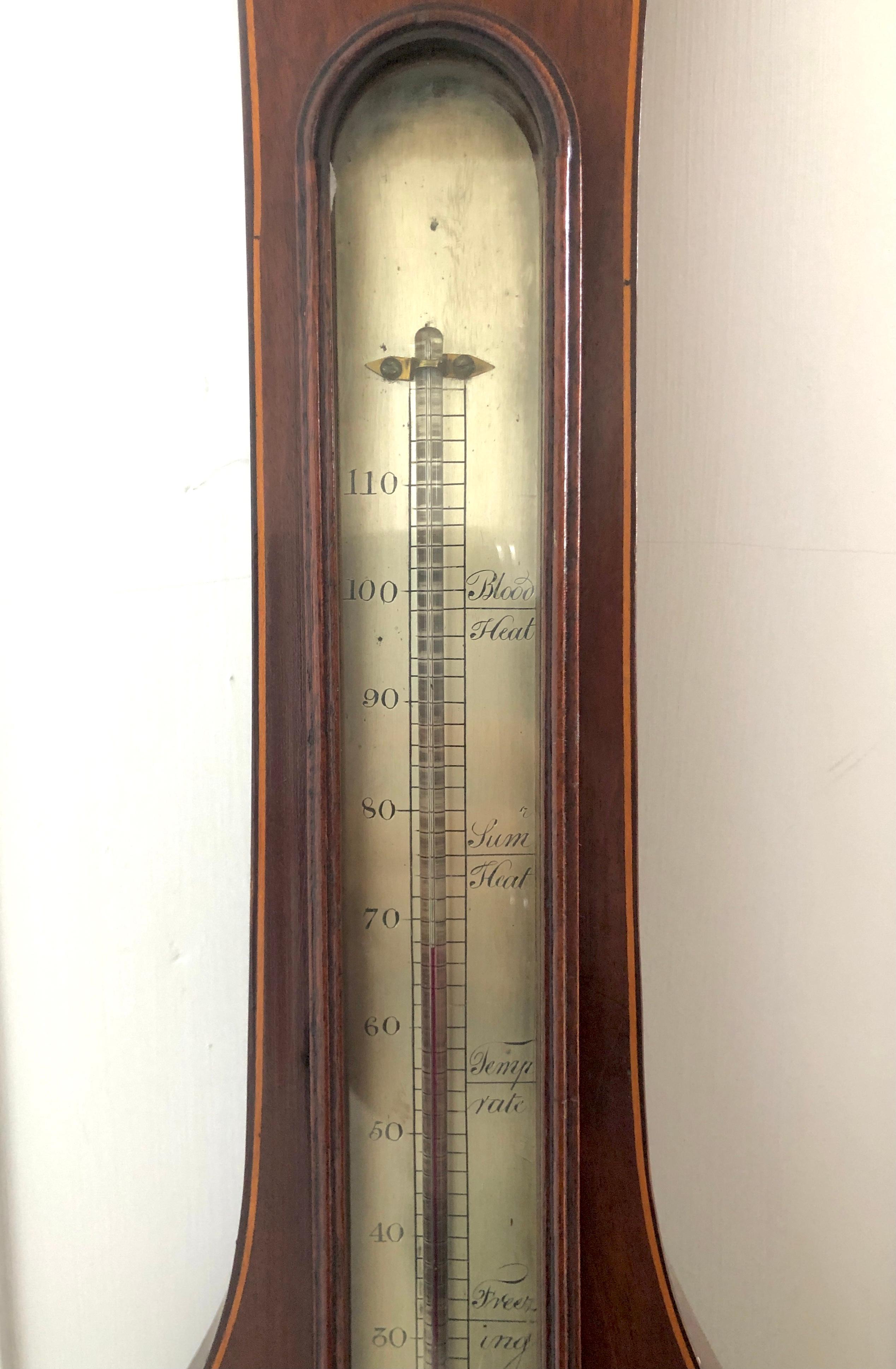 Antique 18th century George III inlaid mahogany banjo barometer having a swan neck pediment with original brass finial, original thermometer and an engraved silvered dial with original hands and brass bezel. The case has been beautifully inlaid with