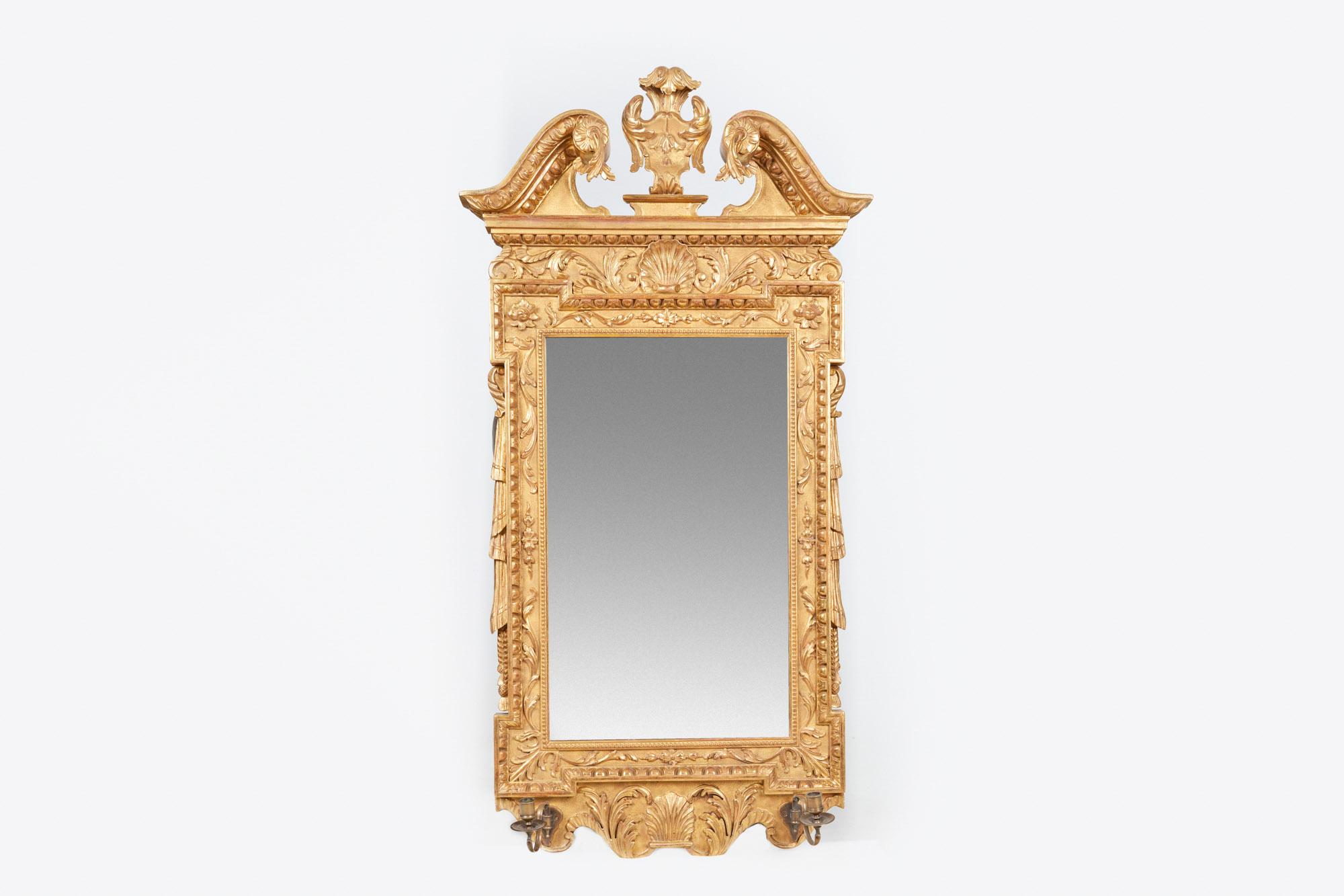 18th century George II Irish water gilded gesso mirror, the period plate glass within carved and moulded frame bordered with beading, foliate and egg and dart relief flanked with stylized tasselled drapery, the cresting centred with plumed cartouche