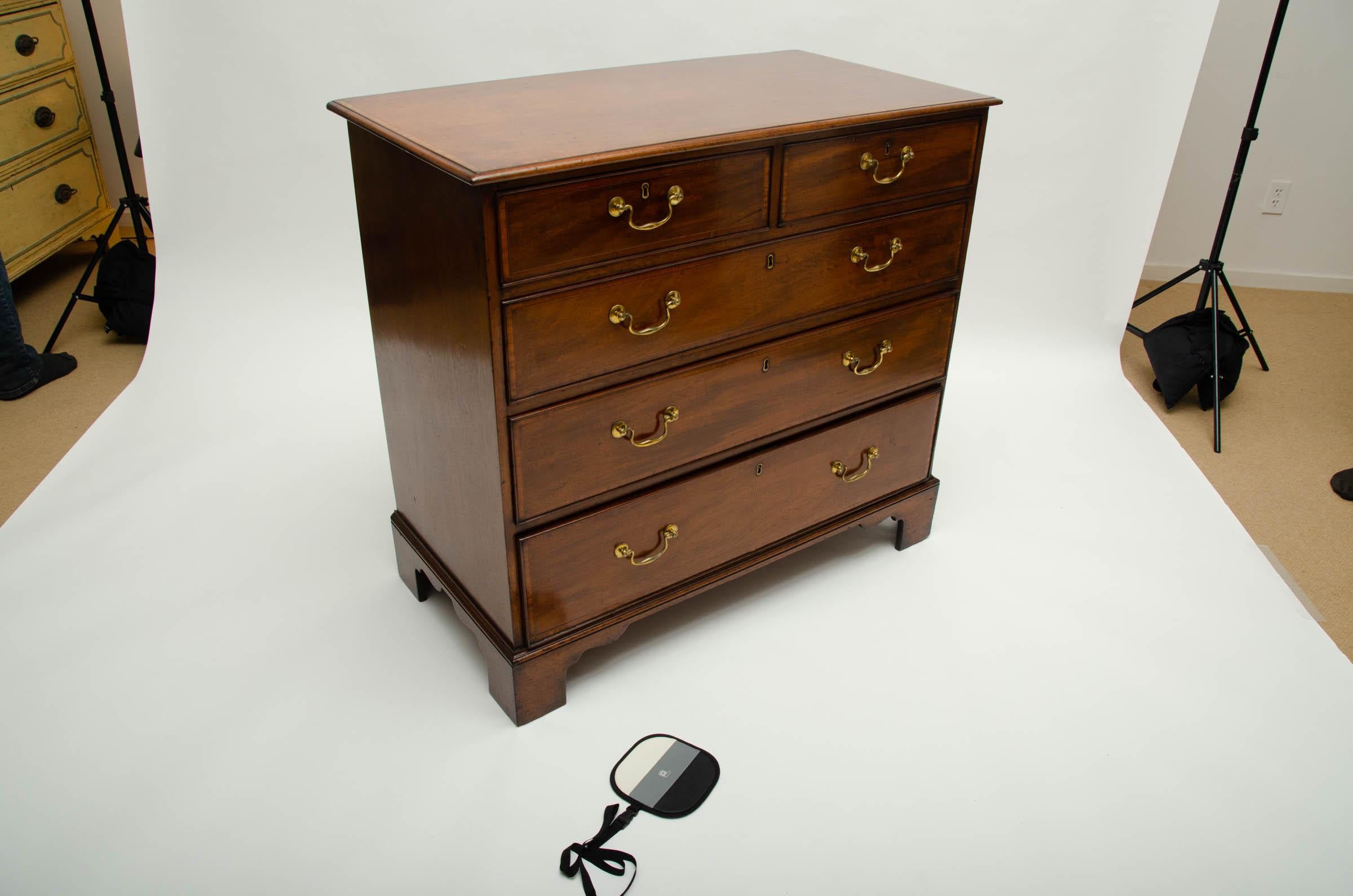 Two short drawers over three long, graduated original brass swan's neck handles and bracket feet.