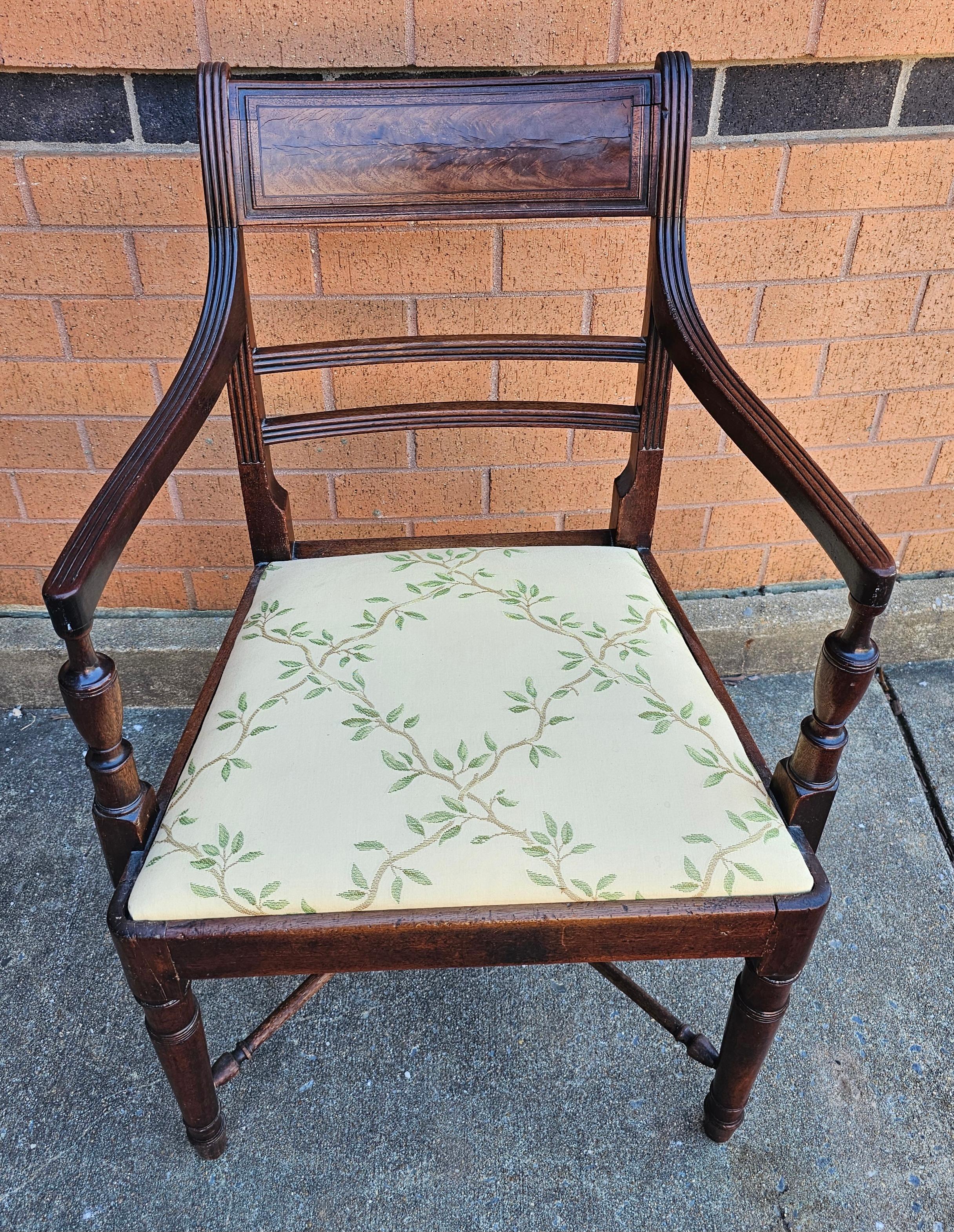 A late 18th to Early 19th Century George III Mahogany upholstered Armchair with X stretcher leg joints. Very sturdy antique condition with newer upholstery. Measures 21.75