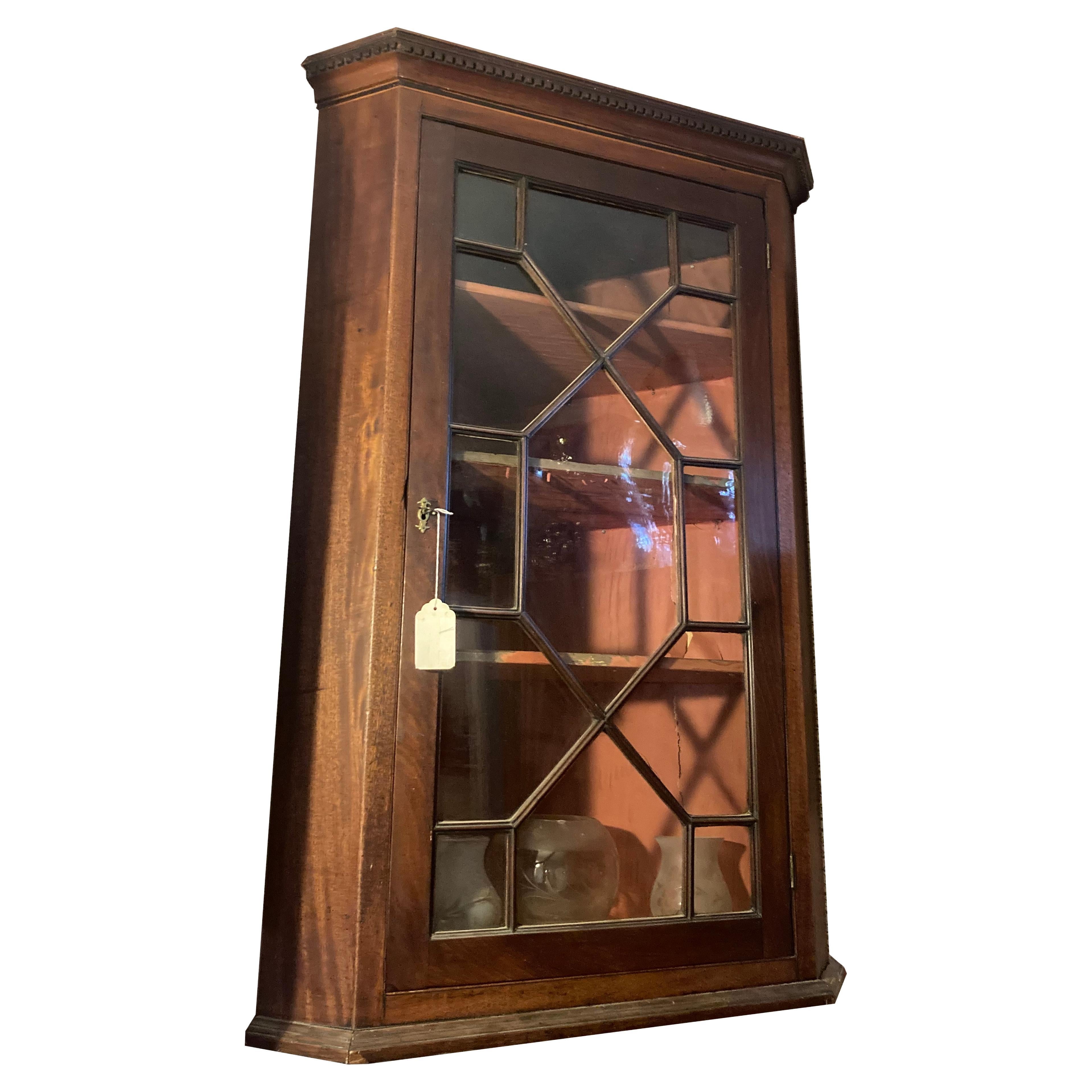 George III mahogany hanging corner cupboard circa 1790.

Small scale hanging cupboard with dentil molding at crown and good door design.

This cupboard measures 41 inches tall by 27 inches wide by 19 inches deep.
