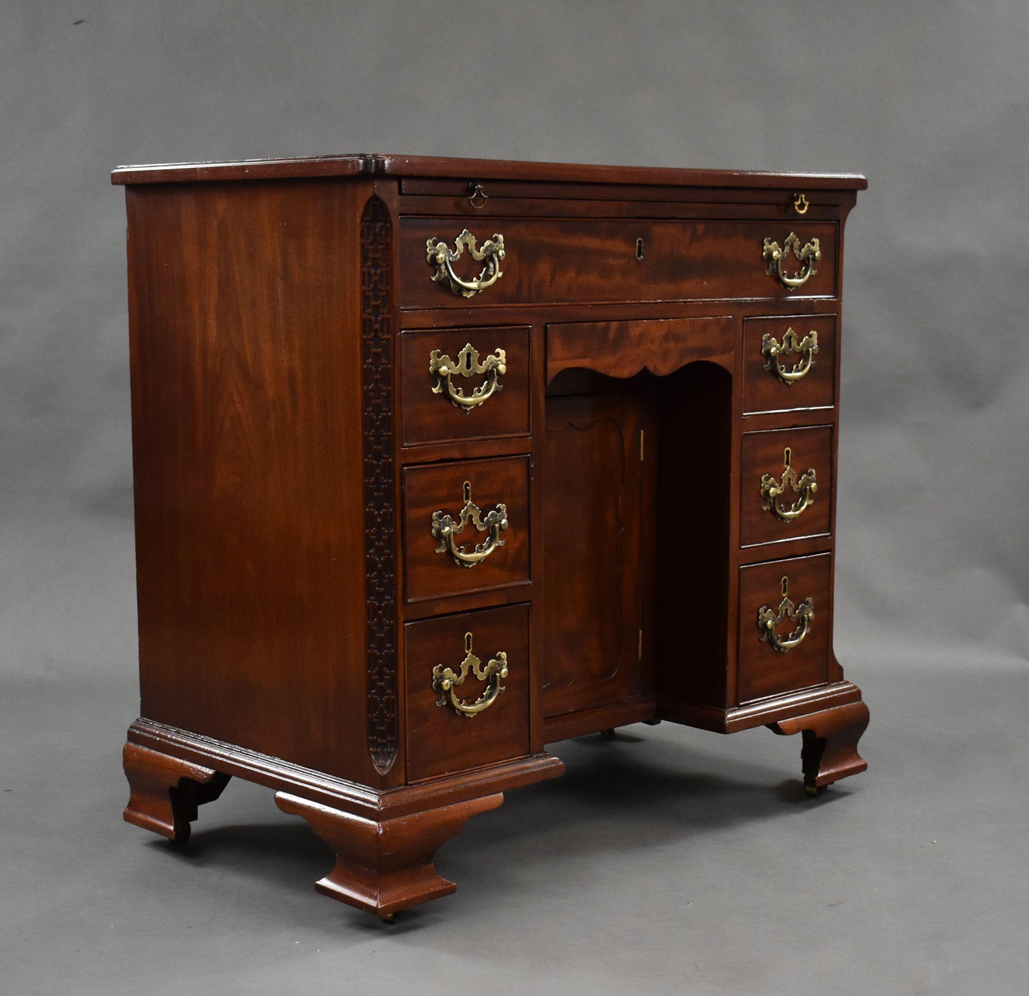 For sale is a very good quality 18th century George III mahogany kneehole desk, having a well figured mahogany top, above a brushing slide with a single drawer below. The desk has a central cupboard with drawers on either side, flanked by ornate