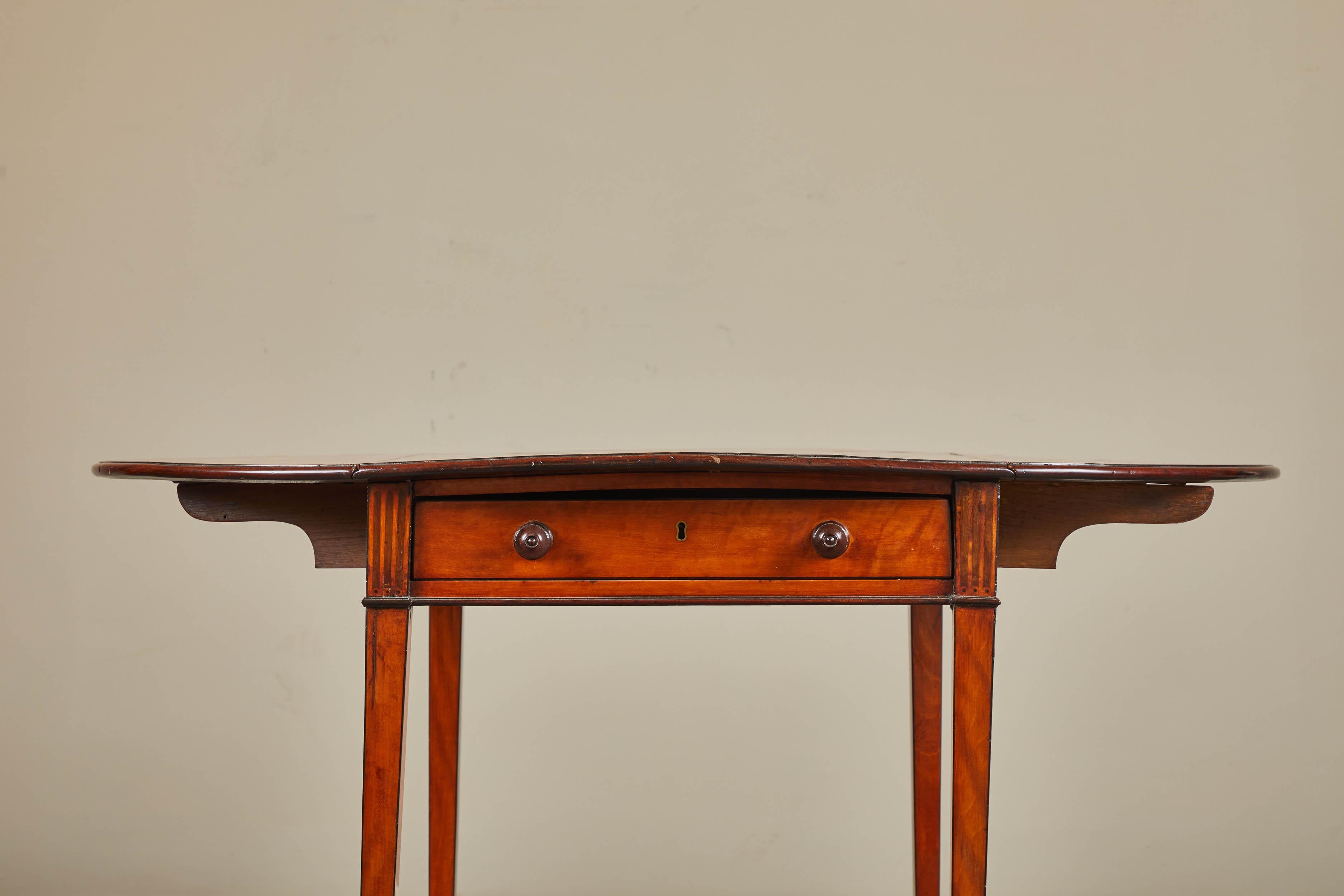 George III Pembroke table with inlaid top and drop-leaves, one working and one faux drawer, sitting on tapered legs.

Measures: 19 1/4 W (opens to 38 3/4) x 30 1/4 D x 28 1/4 H.