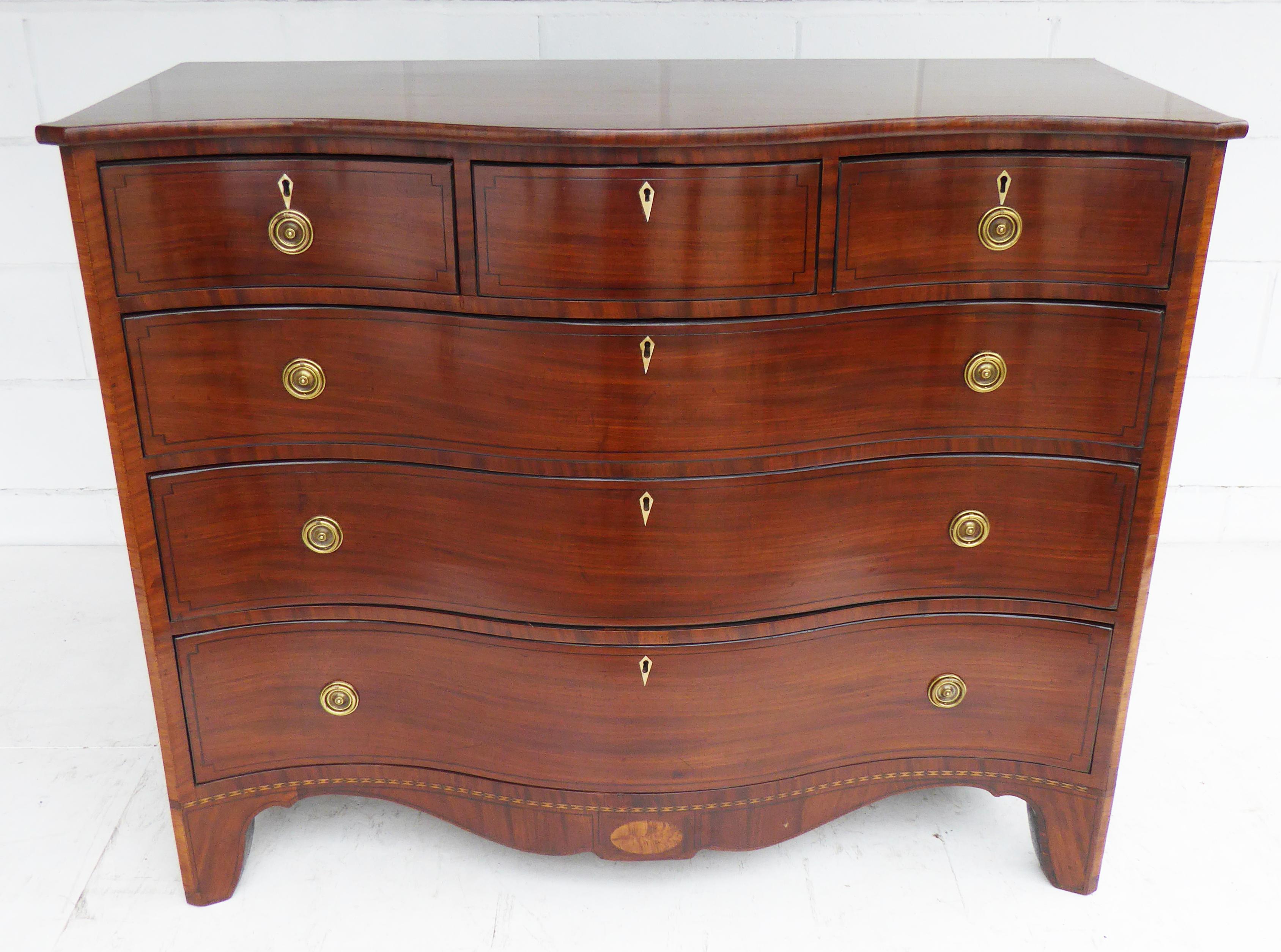 For sale is a top quality George II mahogany serpentine chest of drawers. The chest has an arrangement of three short drawers at the top, with a further three long drawers below. Each with brass ring handles and original escutcheons. The chest of