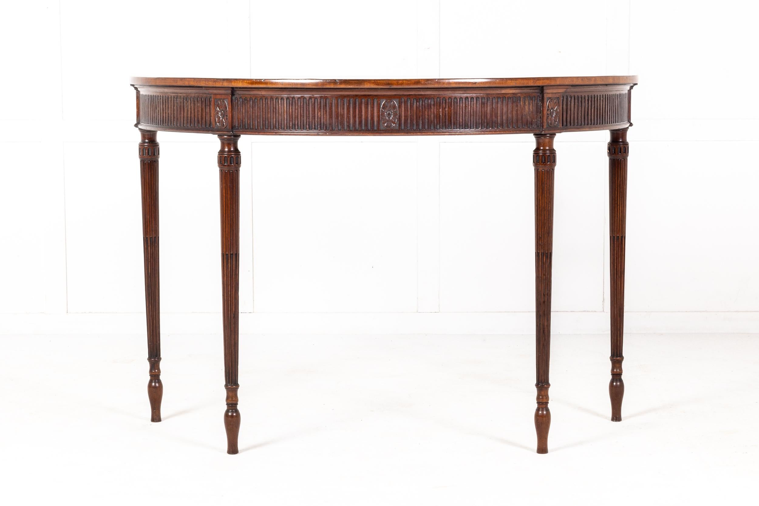 An excellent George III Mahogany Side/Pier Table in the Manner of Thomas Chippendale or Mayhew and Ince, having a finely figured mahogany top of excellent colour, cross banded in satinwood, above a fluted frieze with five finely carved paterae, one