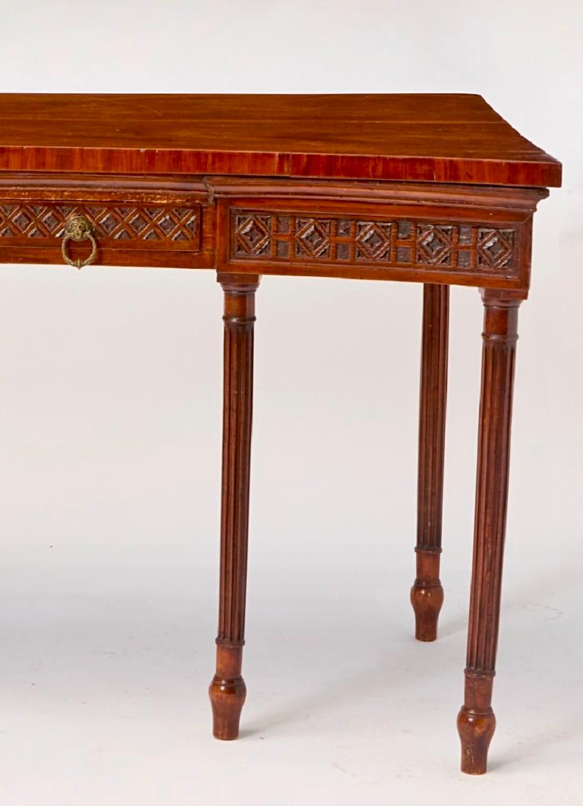 18th century George III shaped mahogany serving table. An elegant George III mahogany rectangular serving table, shaped front with carved apron and two drawers, supported by six round carved fluted legs. Lion head bronze handles. Dates to the late