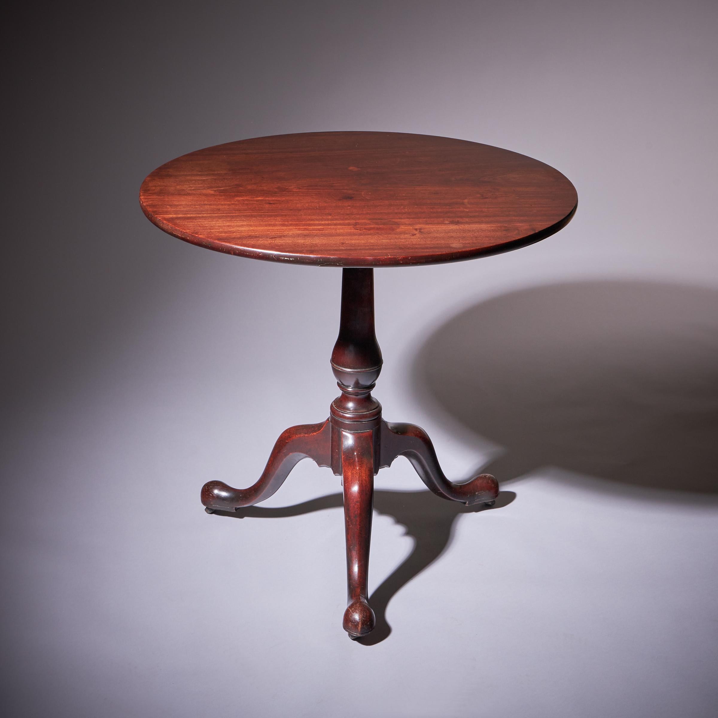 18th Century George III Cuban Mahogany Chippendale Period Tripod Table, Circa 1770. 
England. 

The circular one piece top is raised on a turned baluster centre column and cabriole leg,s terminating on shaped pad feet retaining the original leather