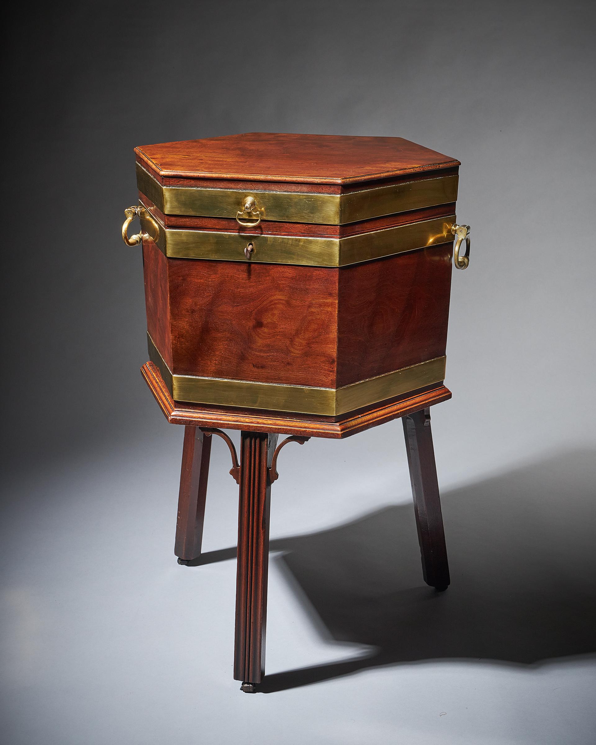 A fine and well-figured George III mahogany hexagonal wine cooler or cellarette on the original stand, C. 1770 England. In the manner of Thomas Chippendale.

There is always something charming about this sort of cellarette and its hexagonal shape