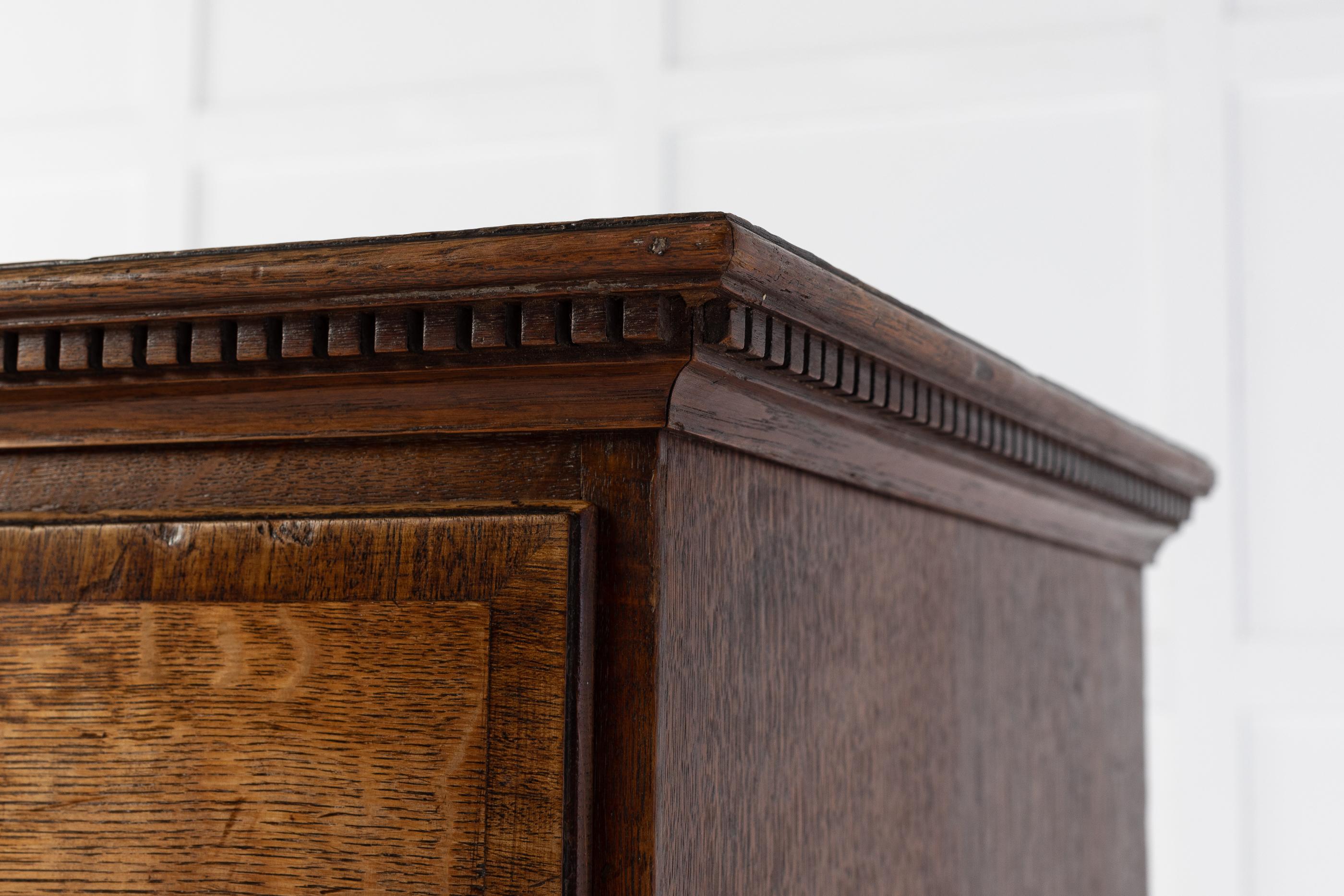 18th century, George III chest of drawers having a dentil moulded top cornice. With two small drawers over four long graduating drawers. Each drawer has choice cuts of oak with oak cross banding and original handles. Standing on its original shaped