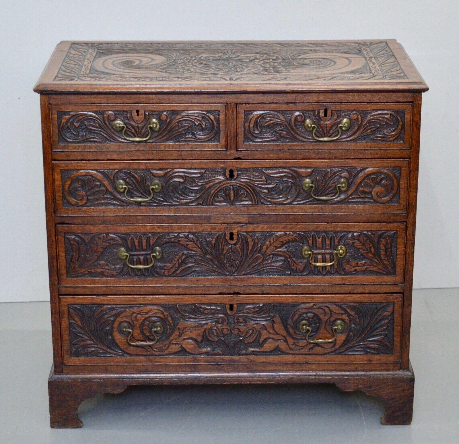 We are delighted to offer for sale this George III oak chest of drawers.
The chest of drawers has a rectangular top with molded edge above two short and three long graduated drawers, bracket feet, later carved throughout with mythical beasts and