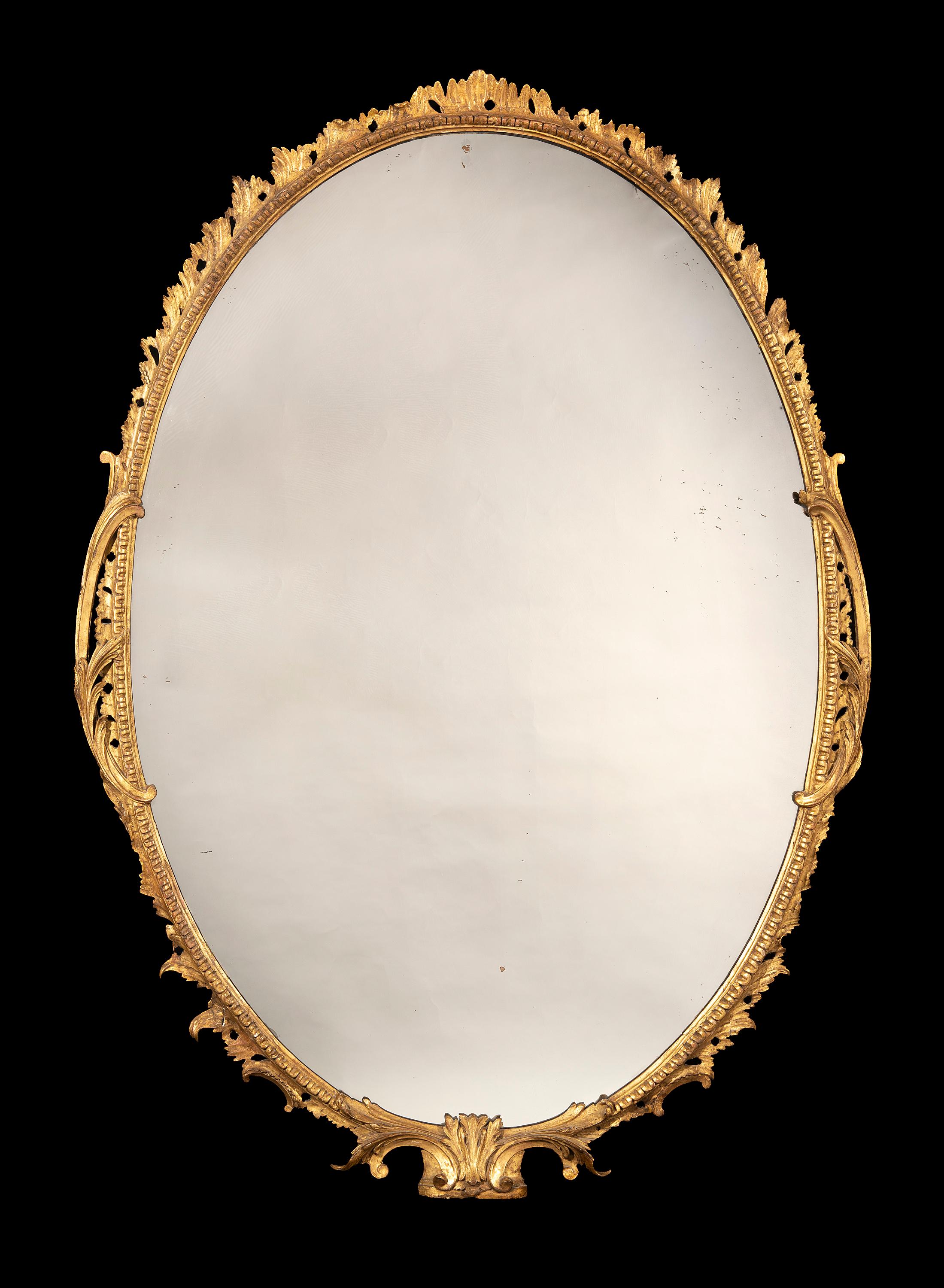 The large carved giltwood frame retains a lot of the old gilding and gesso as well as the original mercury plate.