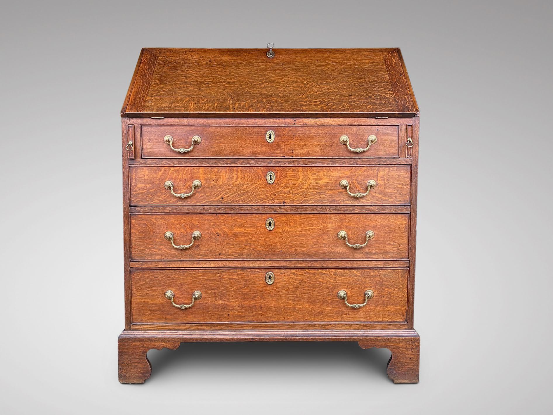 A late 18th century, fine George III period solid light oak bureau. The fall opens to reveal an interior with pigeon holes and drawers, above four long graduated drawers fitted with original brass swan neck handles and escutcheons, standing on
