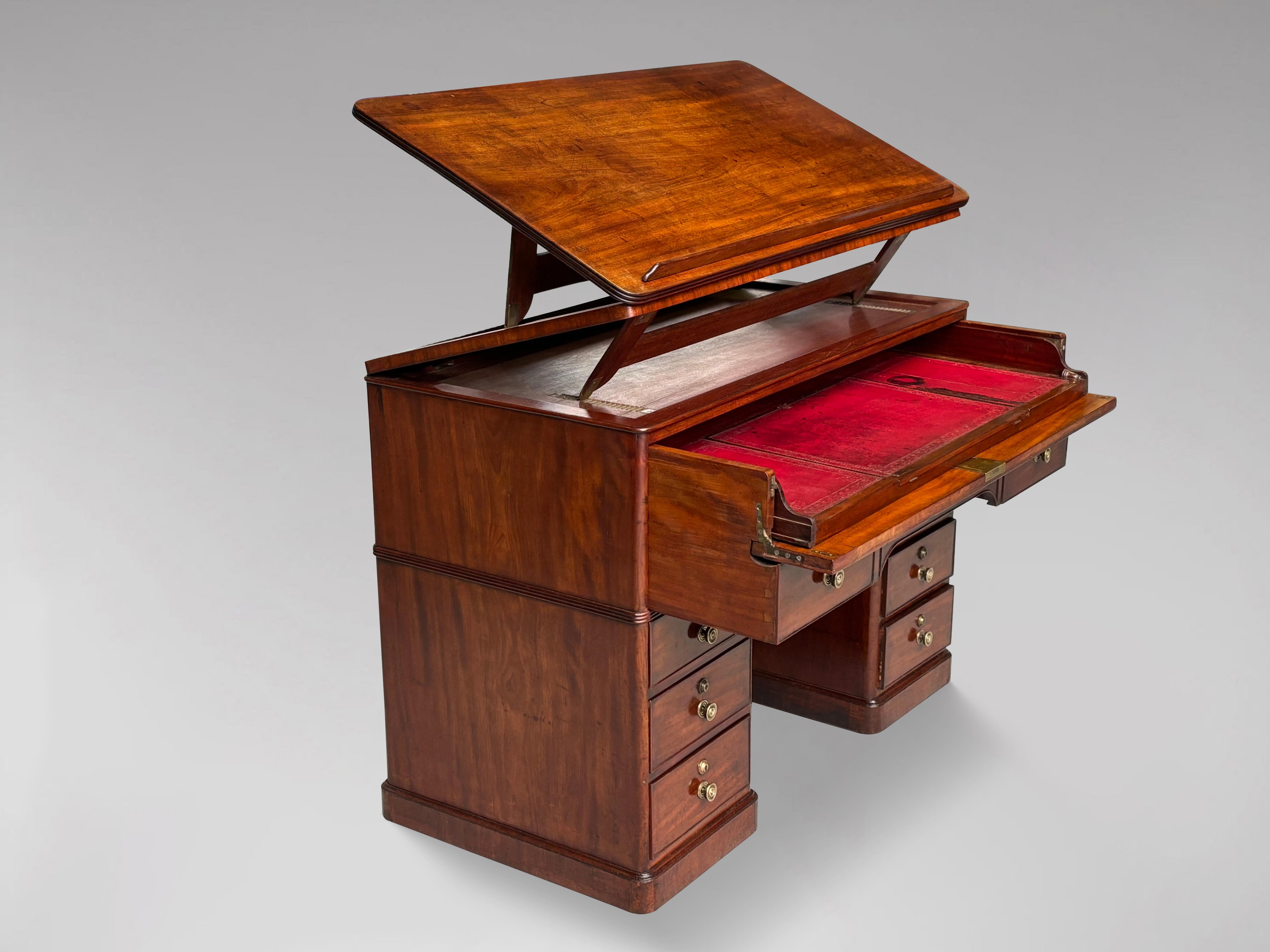 A stunning late 18th century, George III period solid mahogany architect's desk. Finished in the round, the top slants up for reading, or cantilevers up for either reading or writing while standing up. The top drawer opens to reveal a leather topped