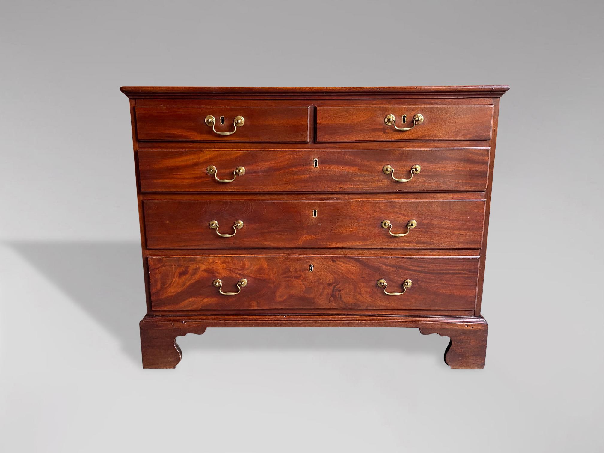A late 18th century, George III period mahogany chest of drawers. Rectangular top, moulded edge above two small and three long graduated drawers with brass swan neck handles, standing on shaped bracket feet. One key with working locks. Rich warm