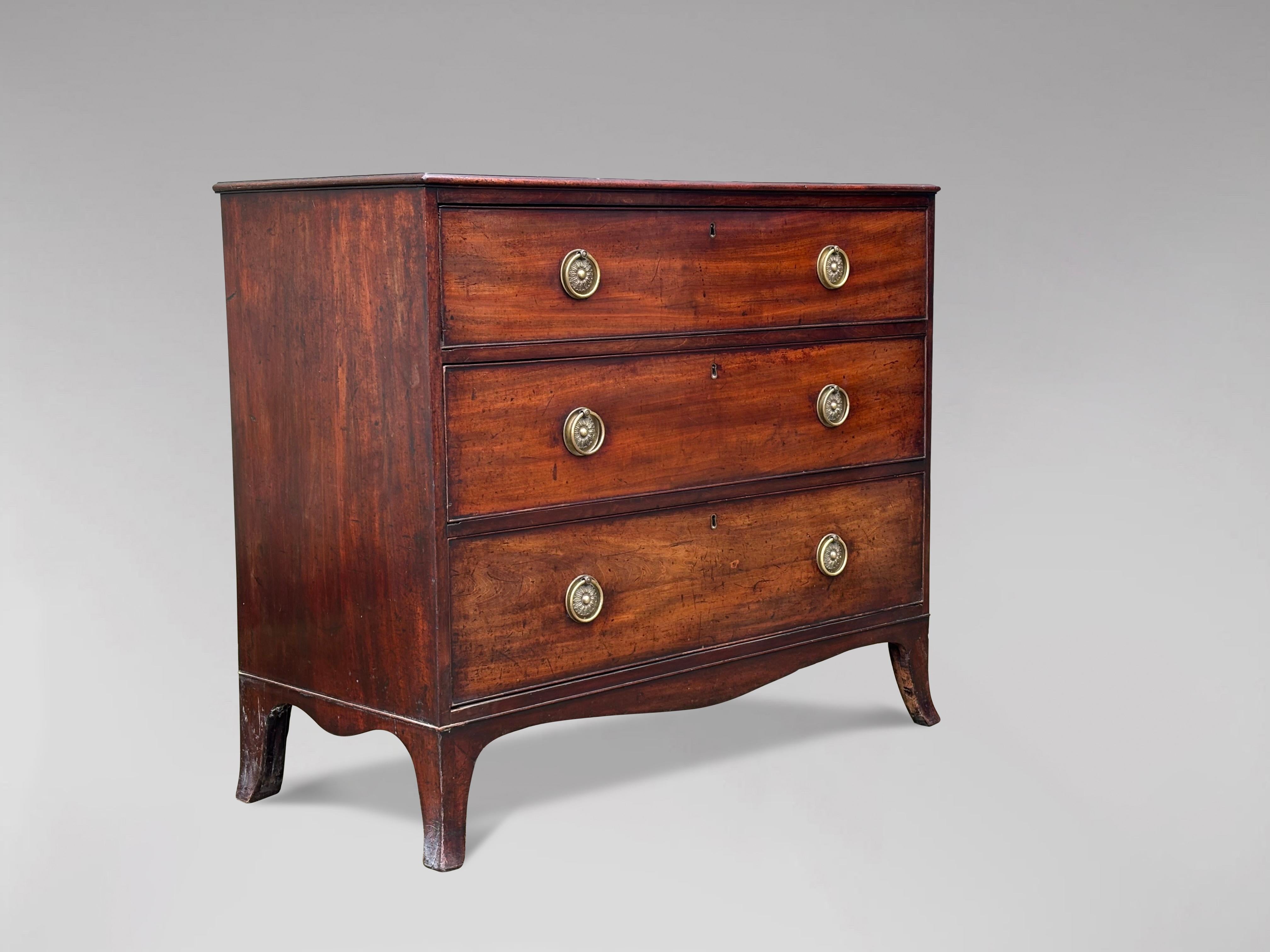 An attractive George III period, late 18th century mahogany chest of drawers. Rectangular moulded top above three long graduated drawers with the original brass ring handles. This chest is supported on bracket splayed feet. Superb original condition