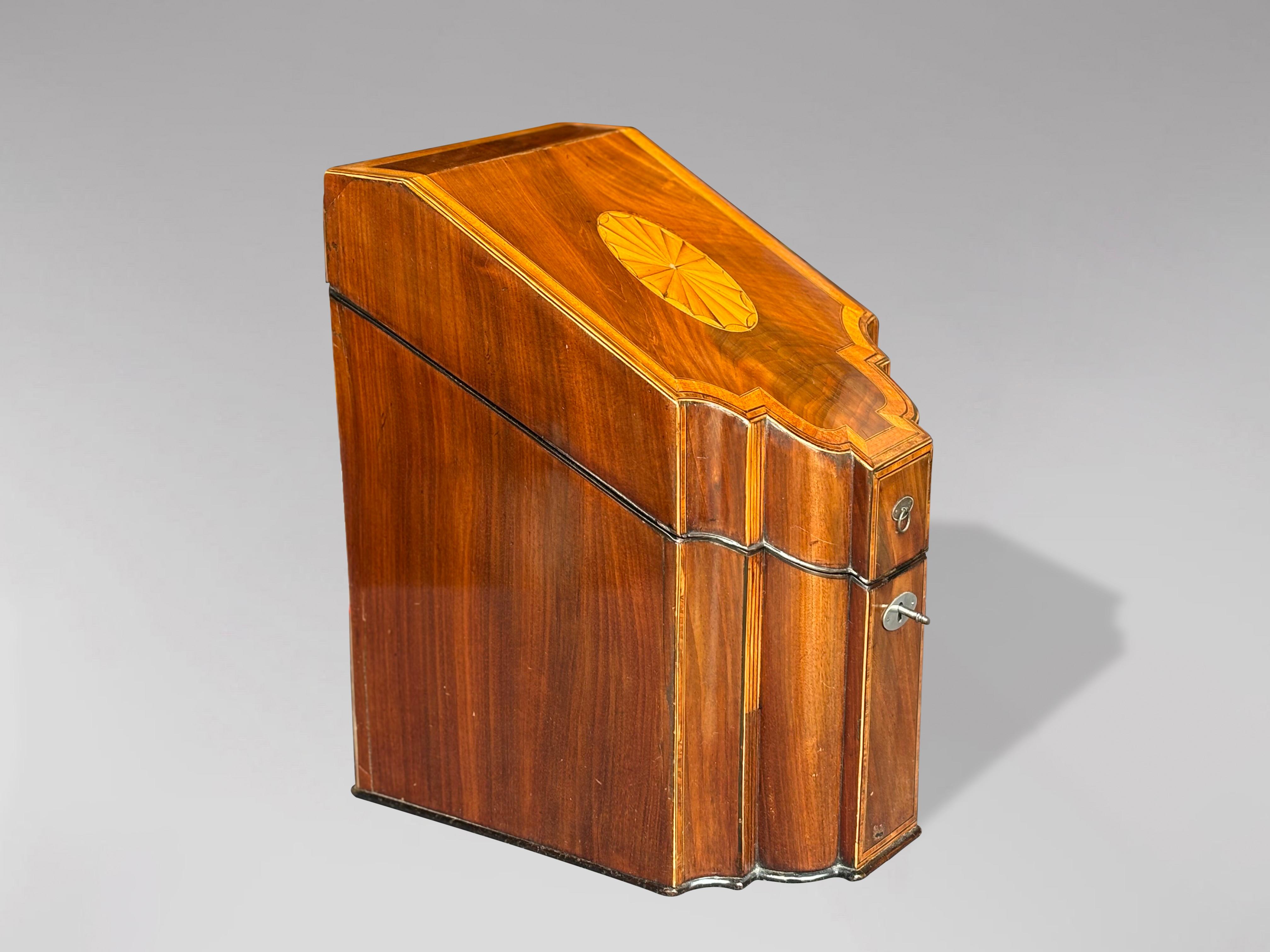 A very fine late 18th century, George III period mahogany knife box or cutlery canteen with fitted interior. Figured sloping lid over a serpentine front with a marquetry inlaid paterae on top, satinwood crossbanding and rosewood & ebony chevron