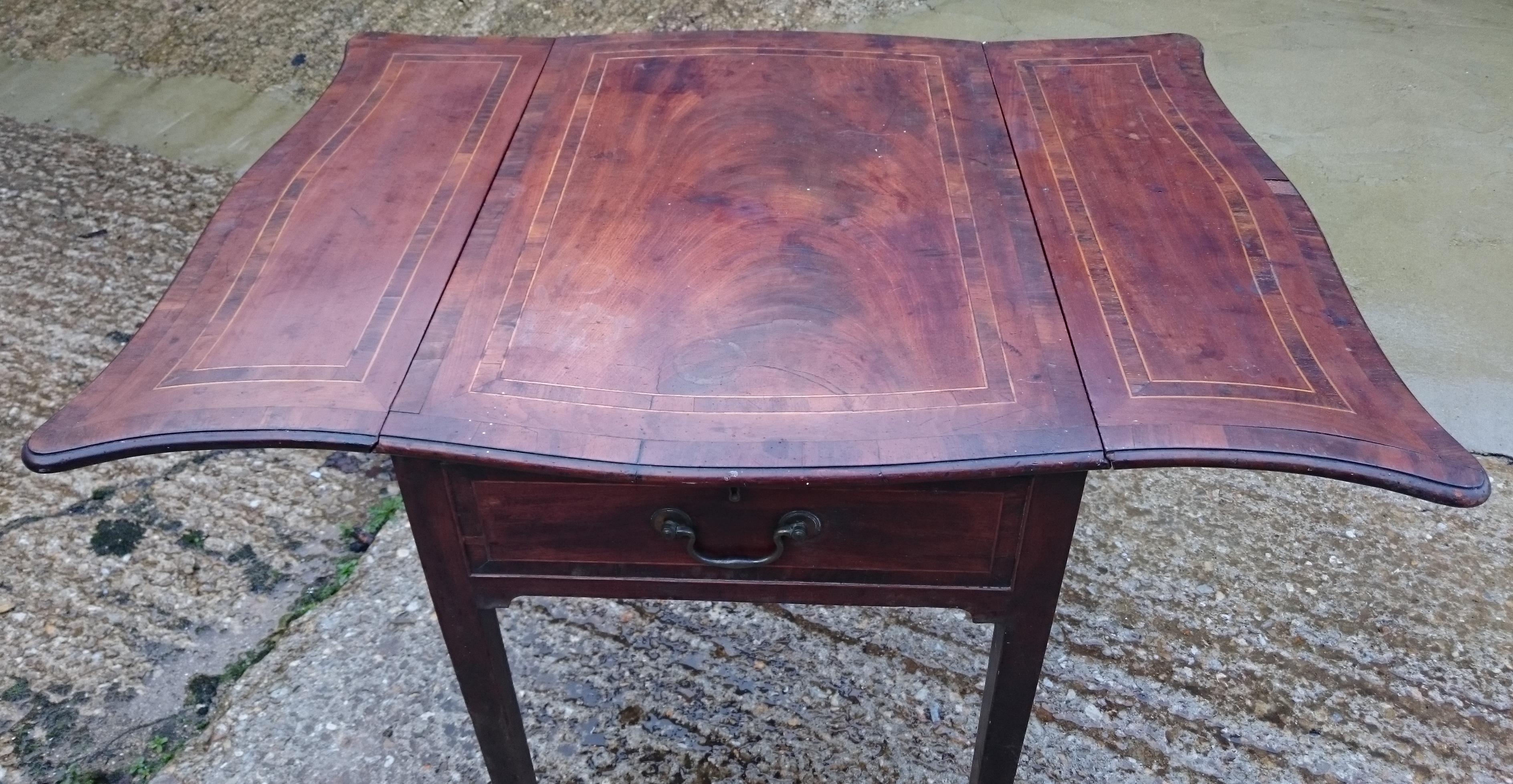 Eighteenth century George III period mahogany antique Pembroke table. This pretty little table is really outstanding, it is made of an especially interesting cut of mahogany, it has a lovely shaped top, it has mahogany lined drawers, it has
