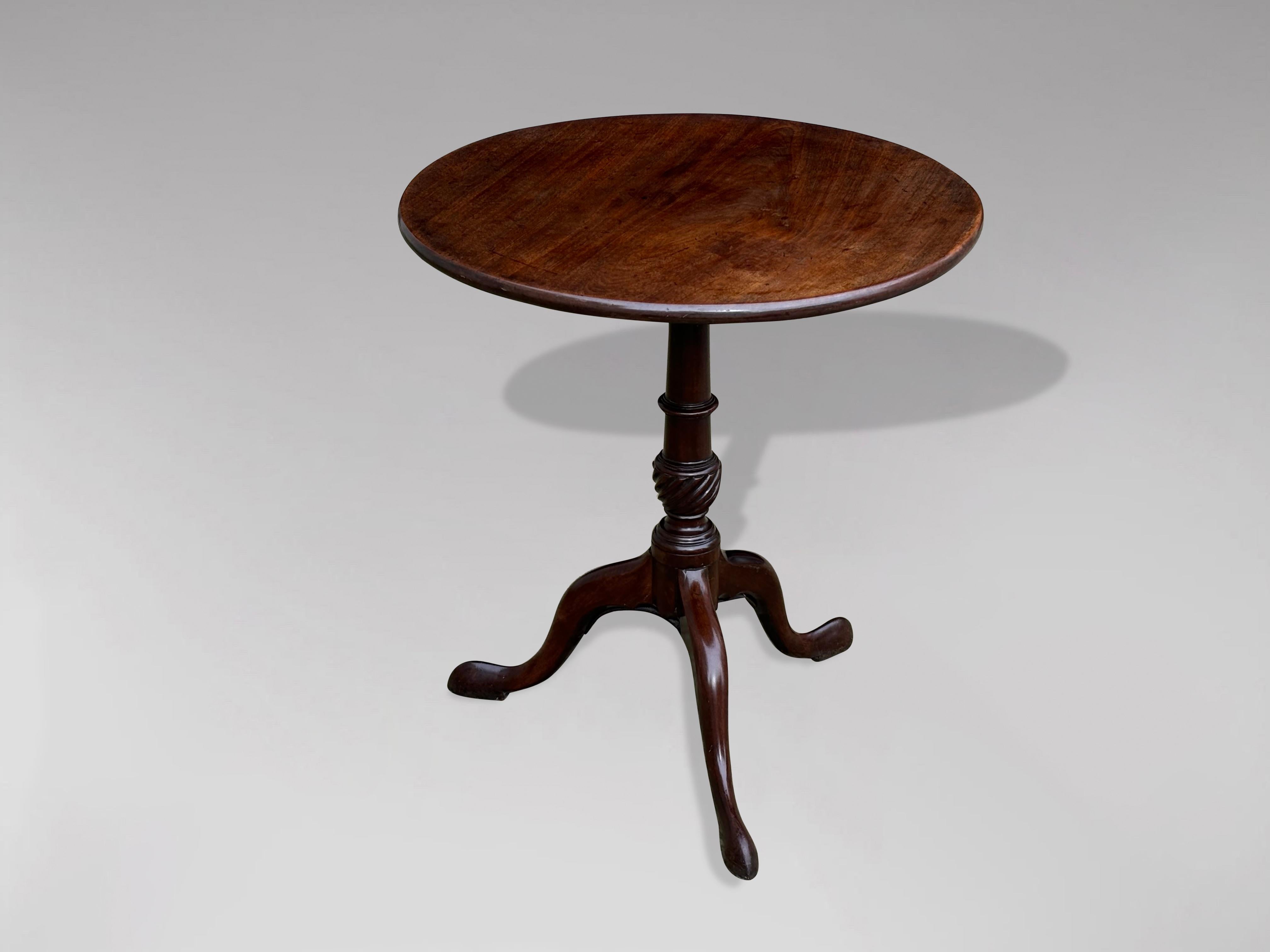 A handsome late 18th century, George III period mahogany tripod table. The well figured single piece of solid mahogany tilt-top circular top, above a turned baluster form column with vase shaped stem and raised on well drawn cabriole legs which