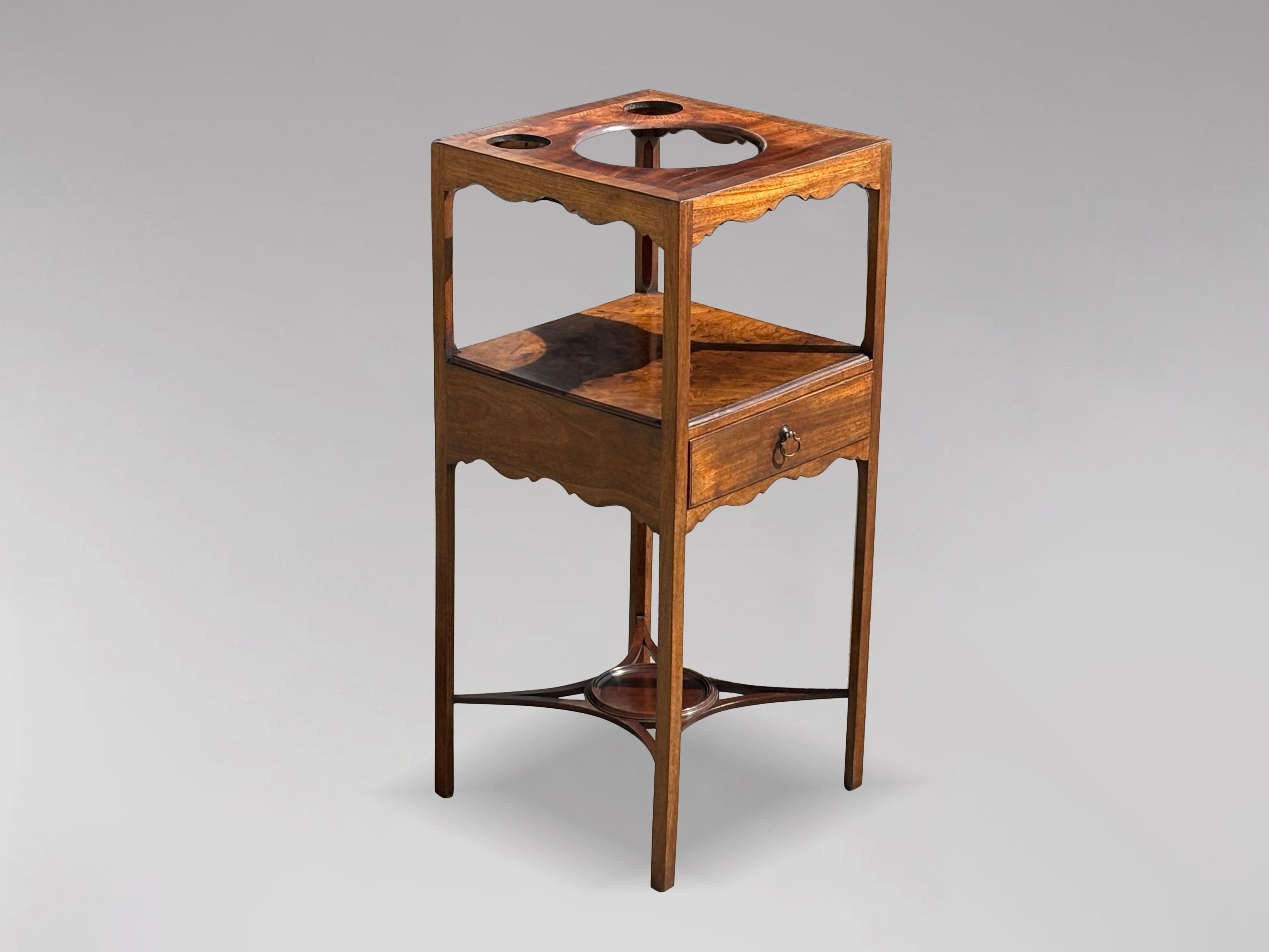 A fine late 18th century George III period mahogany wash stand. The square top pierced to accommodate a washbowl. The jug and basin would have been pottery. Now with a removable boarded mahogany top. Above arched frieze and lower shelf over a single