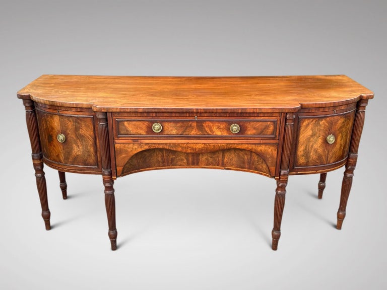 We are delighted to offer for sale this fine quality, good proportioned late 18th century, George III period mahogany and inlay sideboard with a breakfront top. Central cutlery drawer with bowed linen drawer below flanked by a door and a cellarette