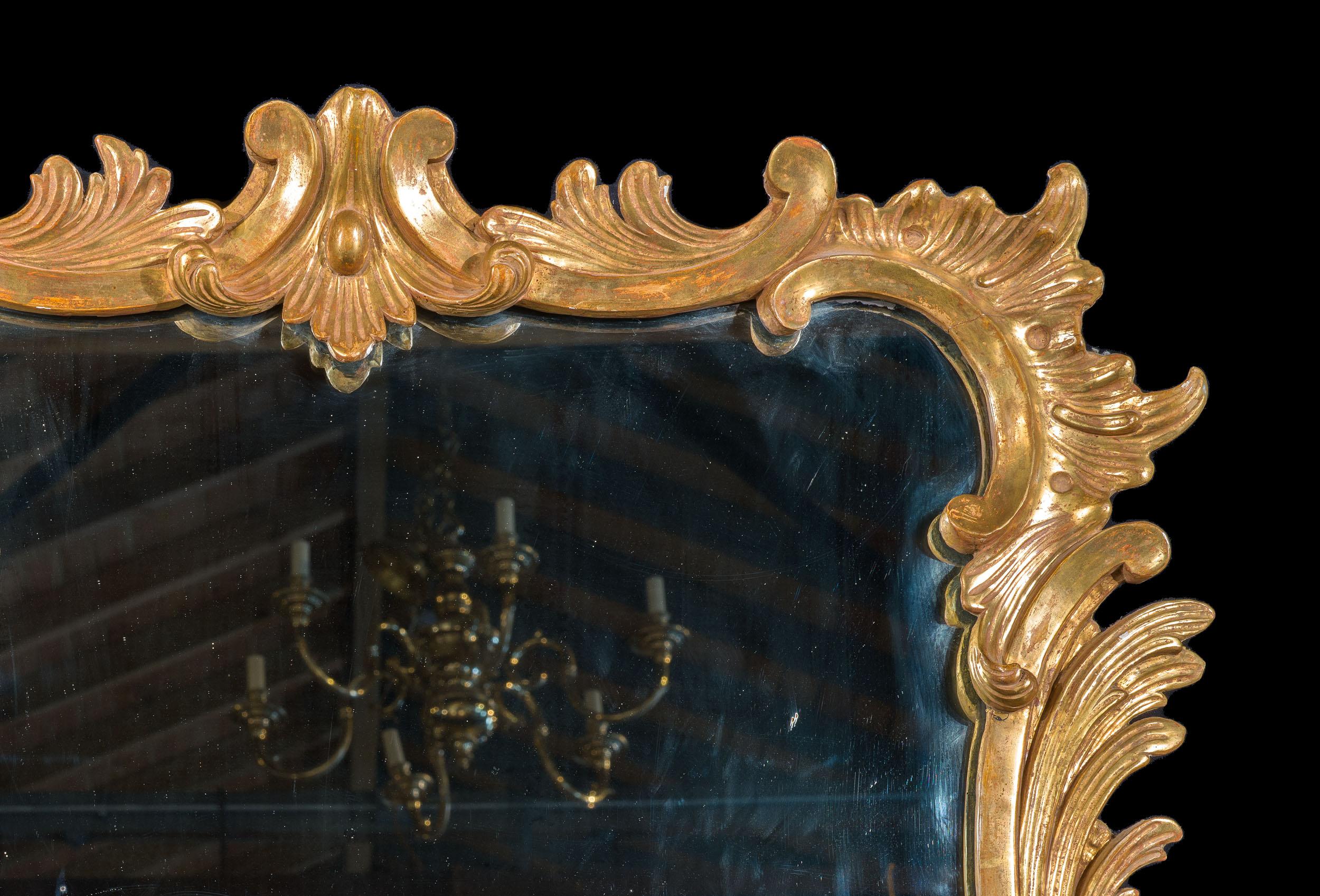 A fine George III English Rococo period giltwood wall mirror, the frame carved with scrolling foliage and c scrolls. Small but perfectly formed!

English, c.1780

Provenance: the property of connoisseur Michael Godfrey.