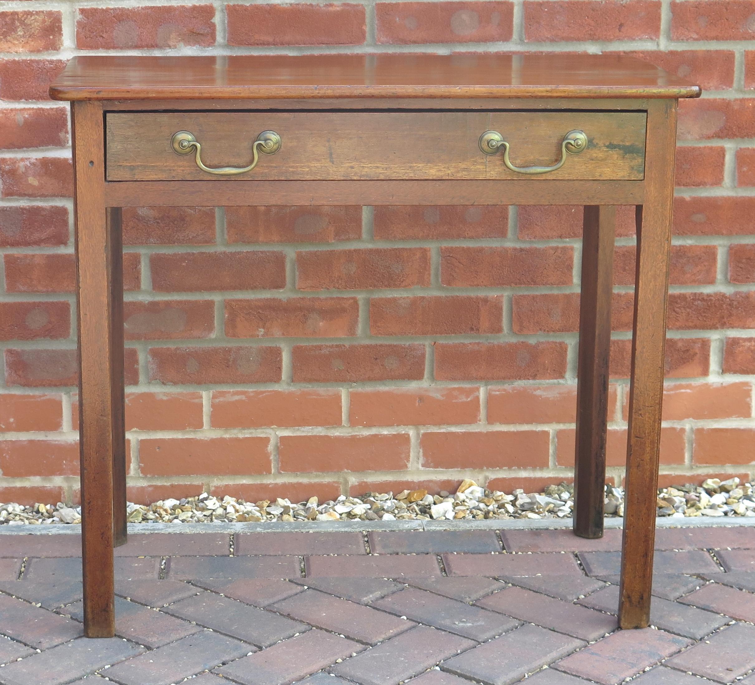 This is a well made solid hardwood ( probably fruitwood) side table with one single drawer, dating to the English George III period of the mid 18th century, circa 1760.

This is a well proportioned Georgian piece of English furniture with great