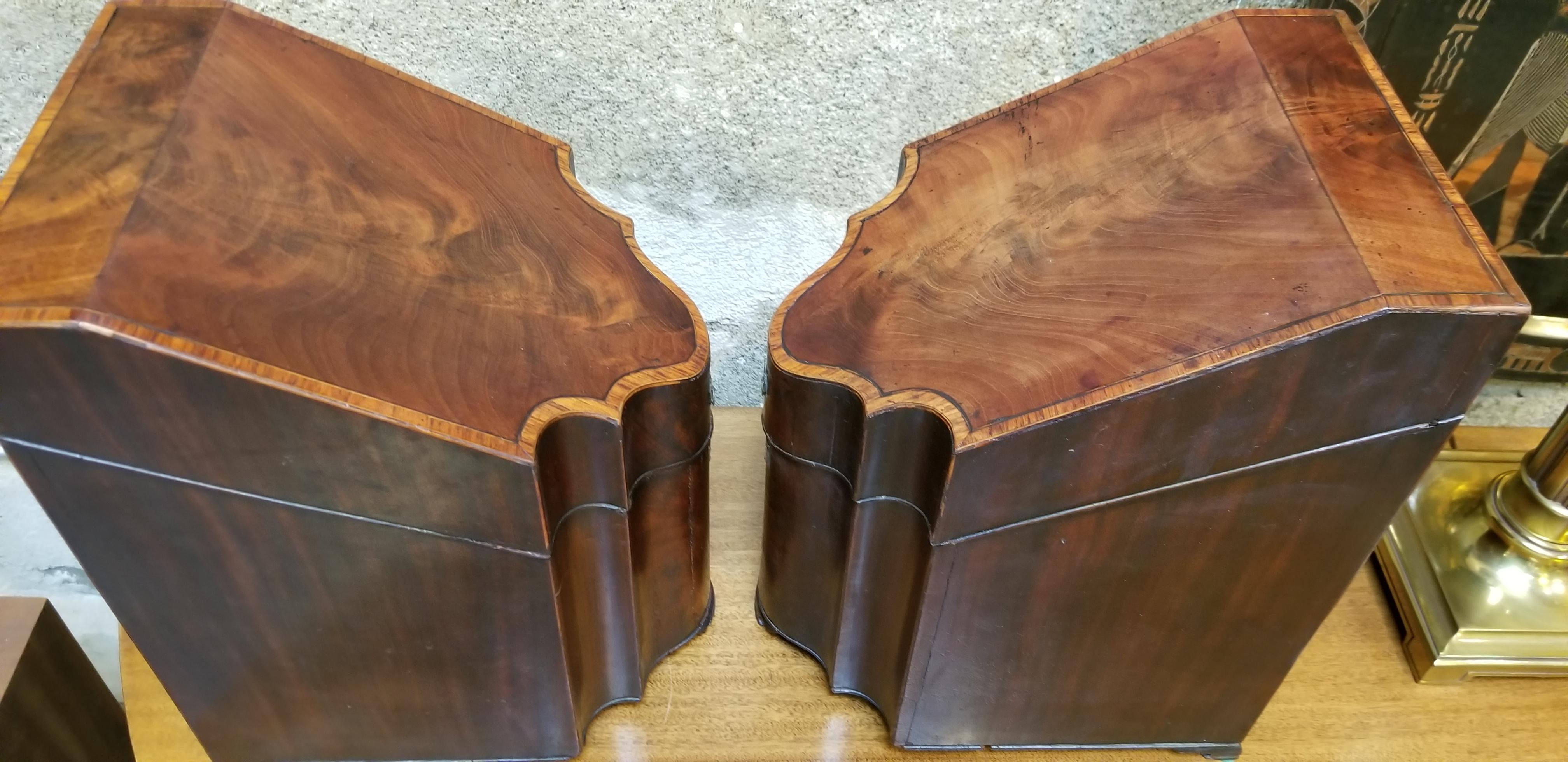 A pair of George III knife boxes hand crafted in a beautiful flame mahogany with inlay detail, circa. 1770-1790. Retaining original locks, escutcheon plates, pulls and inserts. Very good vintage condition with light wear as expected for their age.