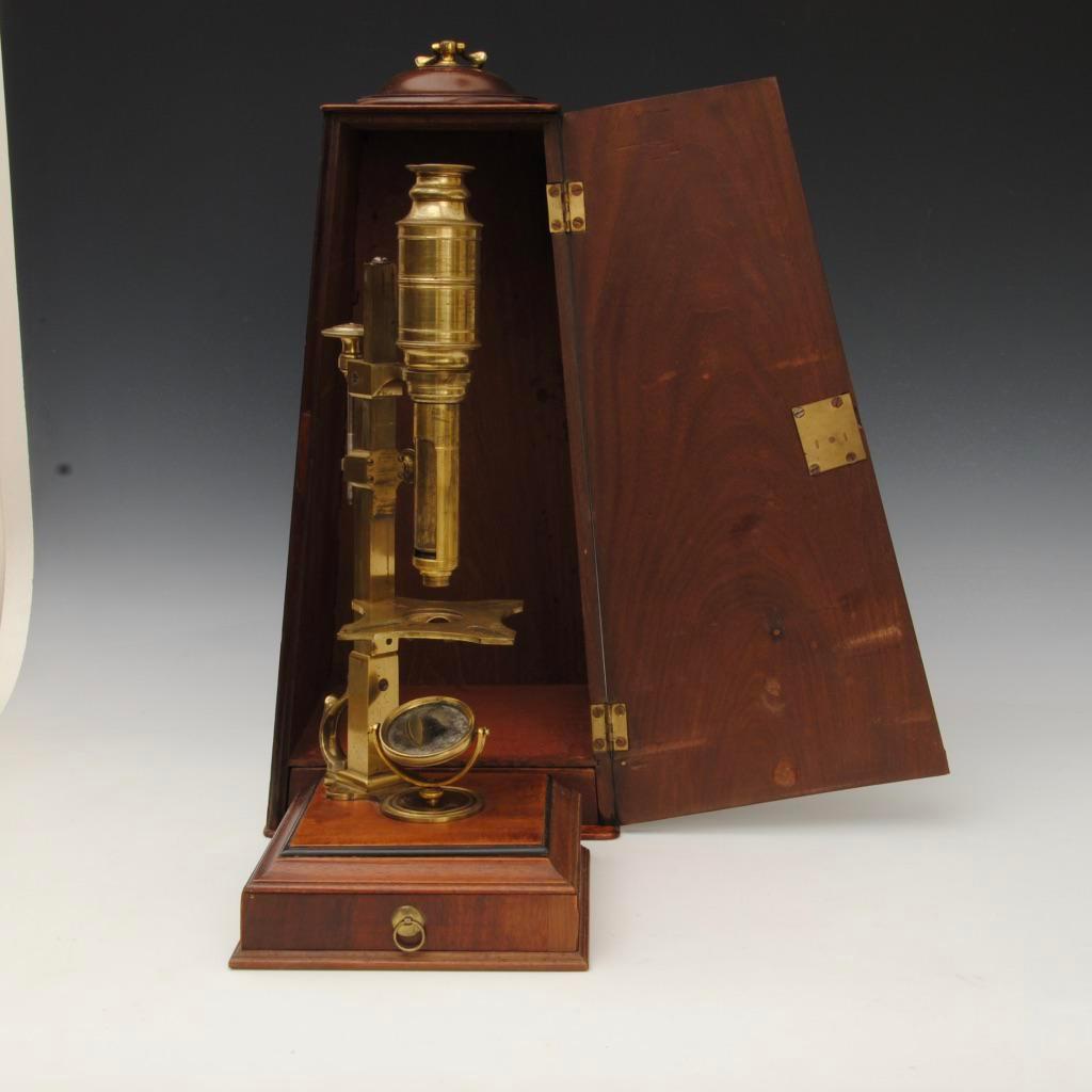 A fine 18th century cuff type microscope by Sterrop, London
The microscope stands on a mahogany base with single drawer fitted with a near complete set of accessories.
A very similar microscope is in the Golub collection

Sizes featured are for