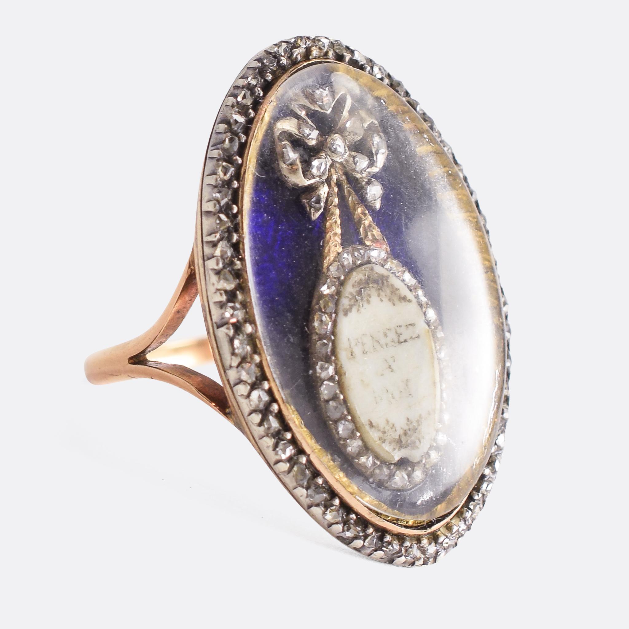 A stunning 18th Century navette memorial ring dating from circa 1780. Behind a domed glass compartment is a diamond-set bow beneath which hangs a plaque with the words PENSEZ A MOI, or Think of Me. The head is bordered with rose cut diamonds, and