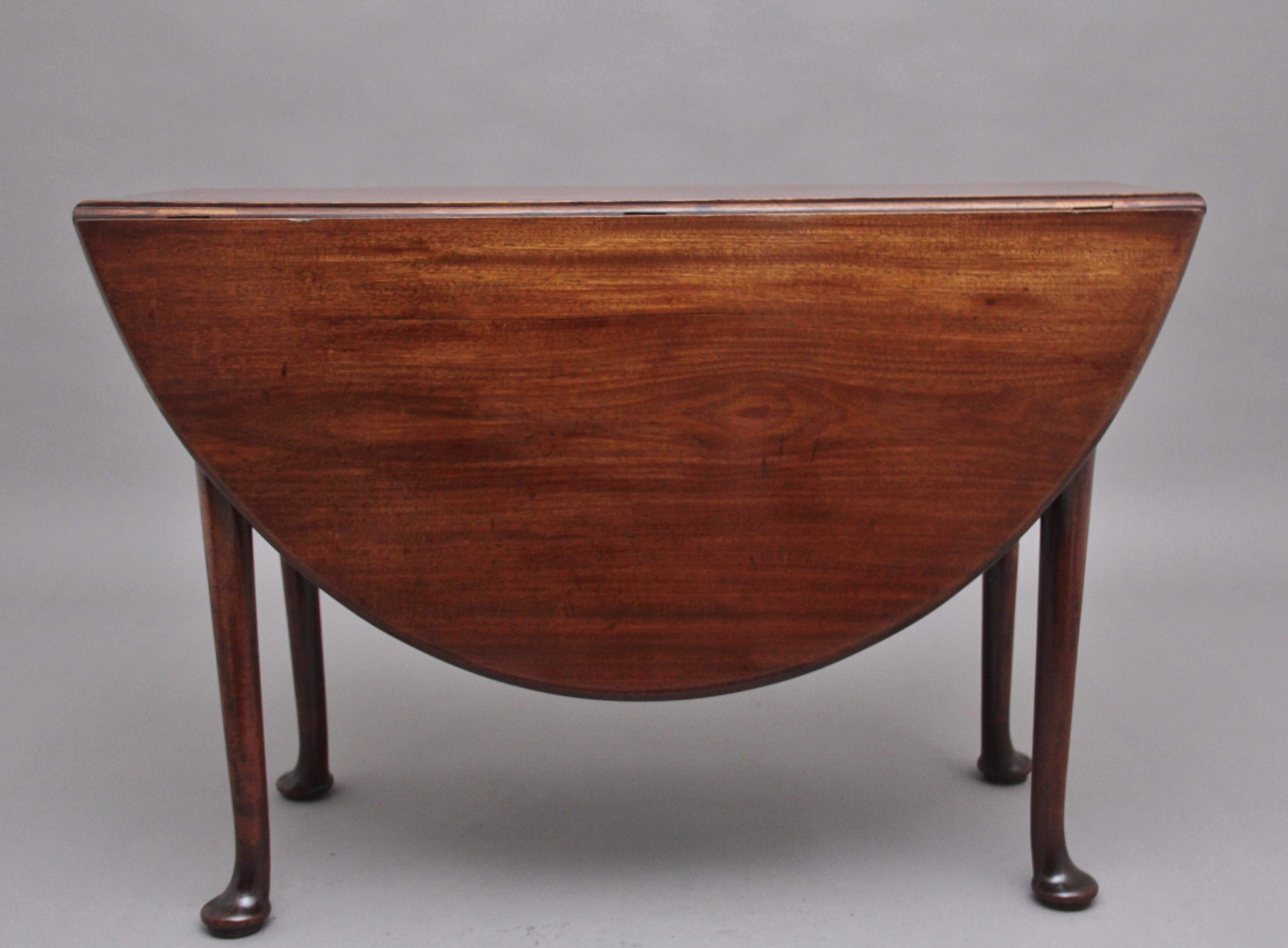 18th Century Georgian mahogany drop leaf table, having a lovely figured solid top, once the leaves are fully extended the top is oval in shape, standing on turned legs with pad feet, having a lovely warm rich mahogany colour and in excellent